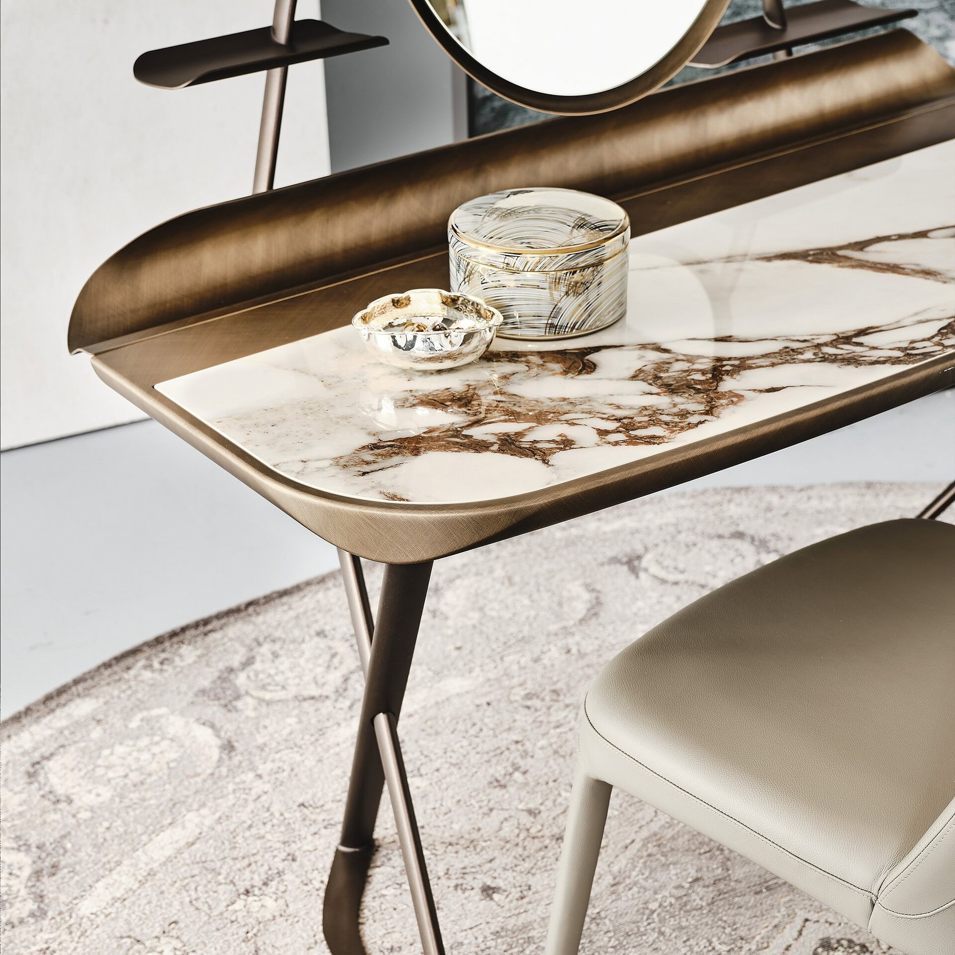 Side angle of Cocoon Trousse vanity showing leather top finish, mirror, and slim X-frame base.