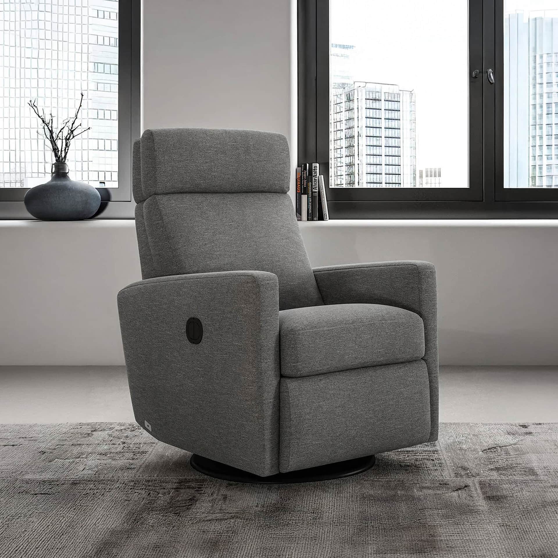 Recliner chair in gray fabric, ideal for modern living rooms and relaxation spaces.