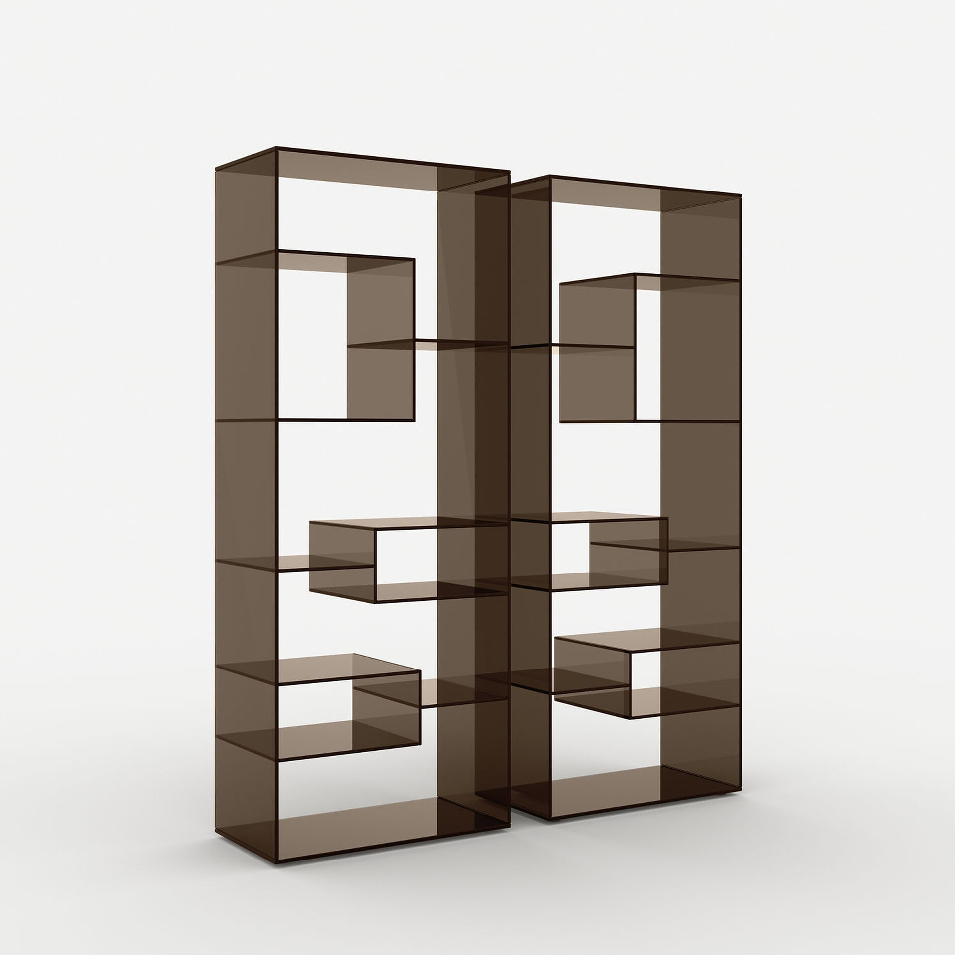 Two tall, modern modular bookshelves made of dark, translucent brown glass or acrylic, featuring an asymmetrical, geometric arrangement of shelves, against a white background.