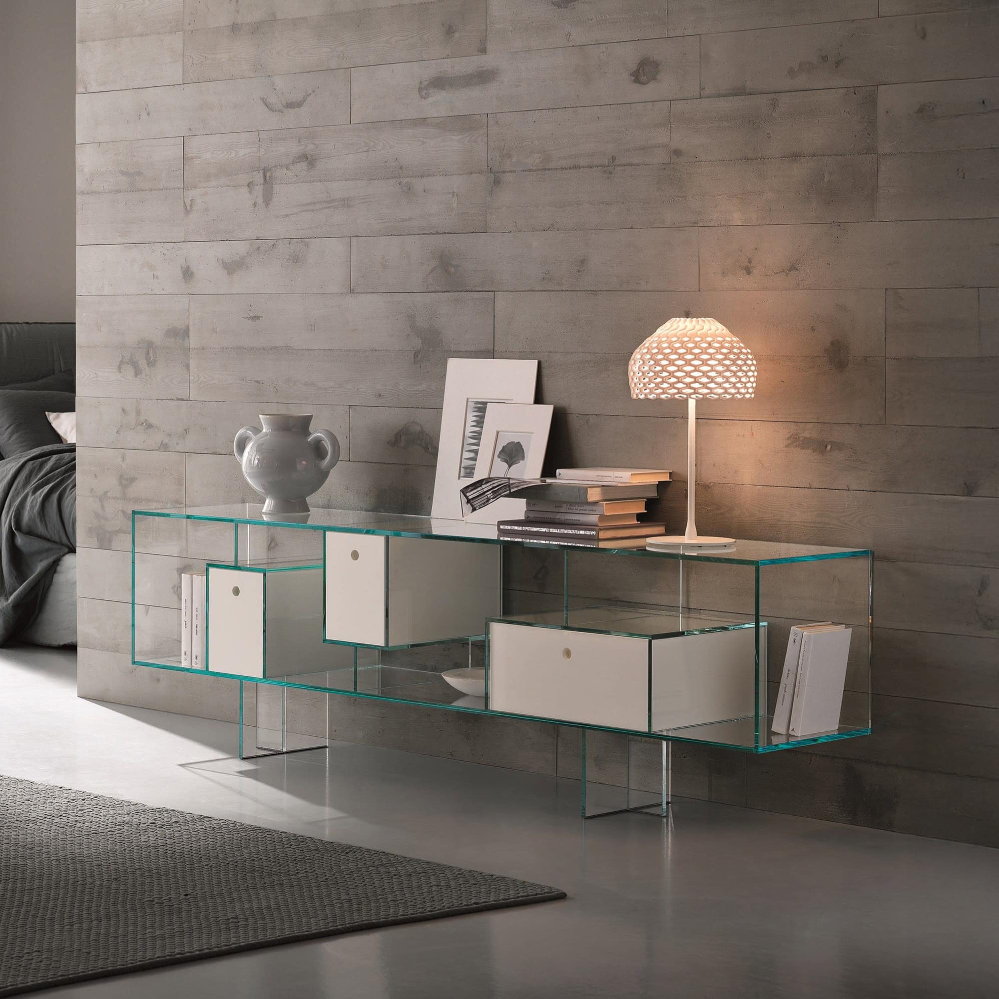 Tonelli Liber low bookcase variation in extra clear glass, styled with accessories and lighting.