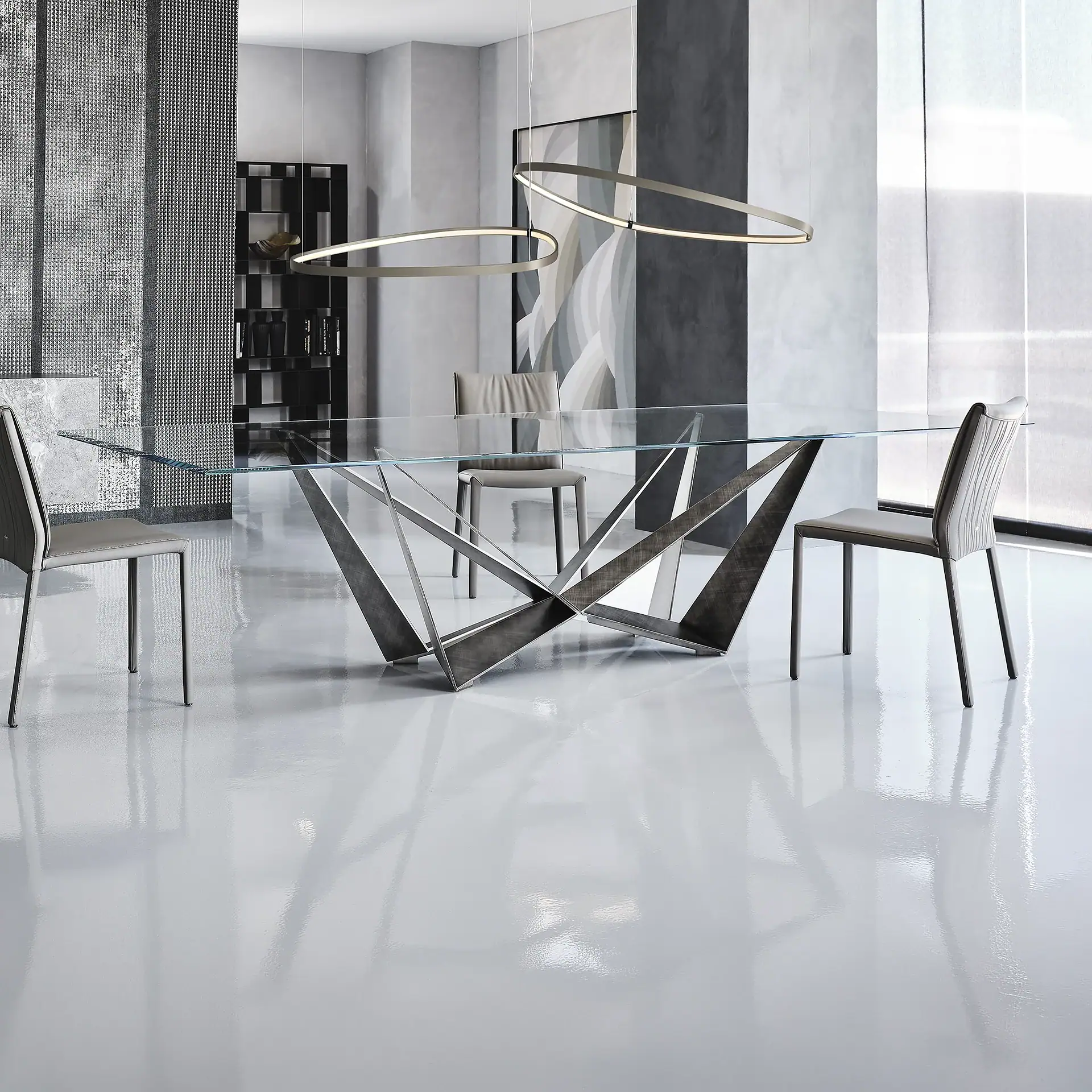 Modern Skorpio Dining Table with glass top and stylish metal base for contemporary dining spaces.