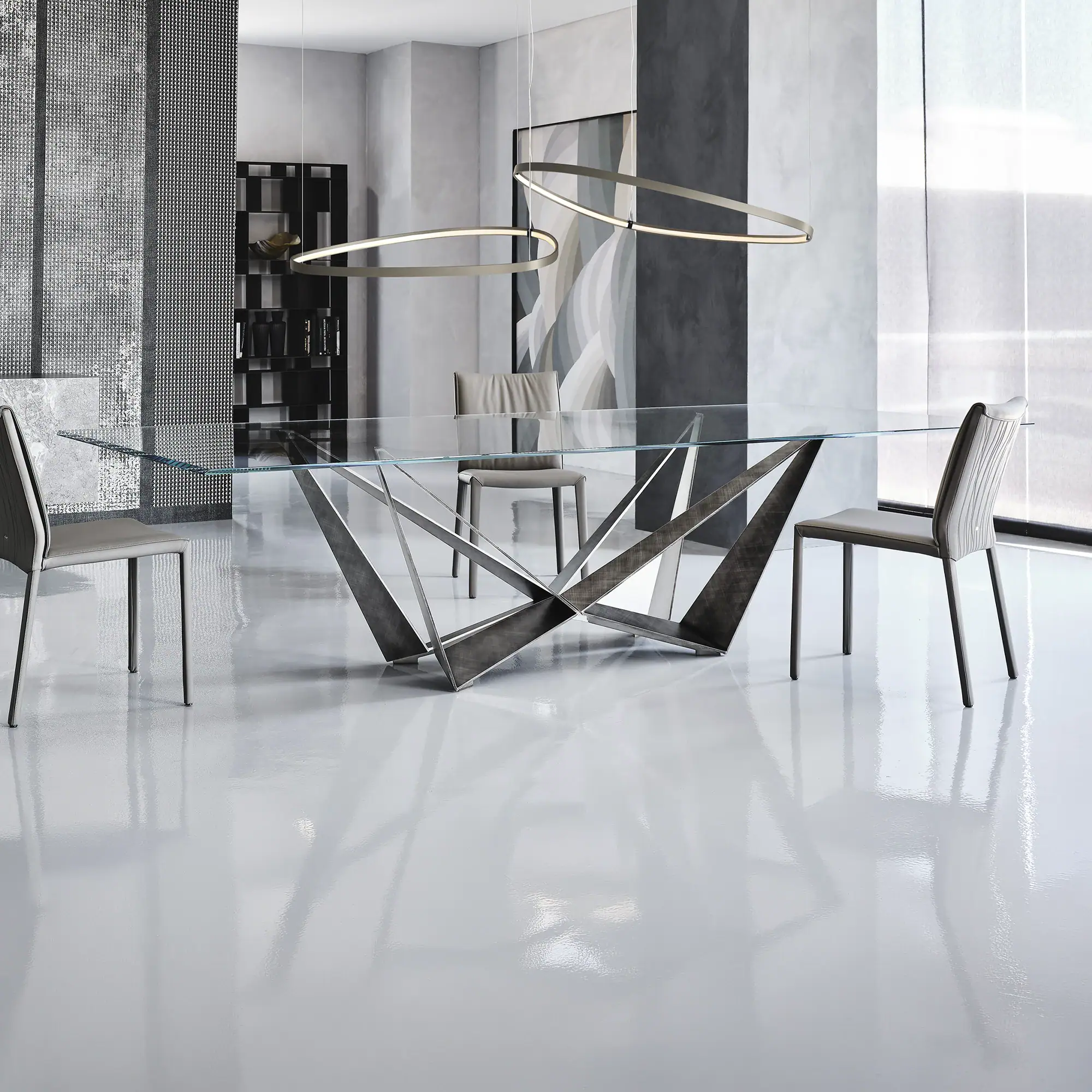 Modern Skorpio Dining Table with glass top and stylish metal base for contemporary dining spaces.