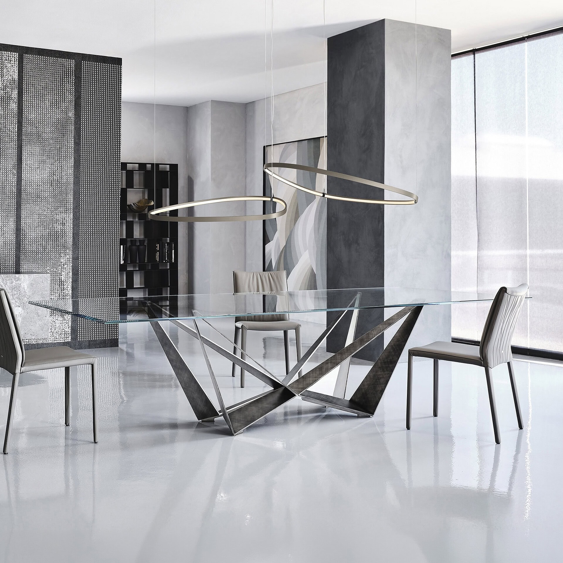 Modern Skorpio Dining Table with glass top and stylish metal base for contemporary dining spaces.