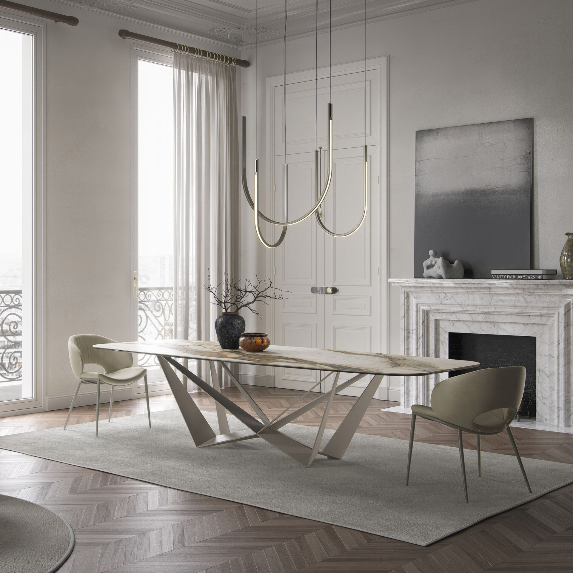 A luxurious dining room with a marble-top table, modern chairs, and a unique chandelier. A white marble fireplace and tall French doors with sheer curtains are visible. The room has herringbone wood floors and a light grey rug.