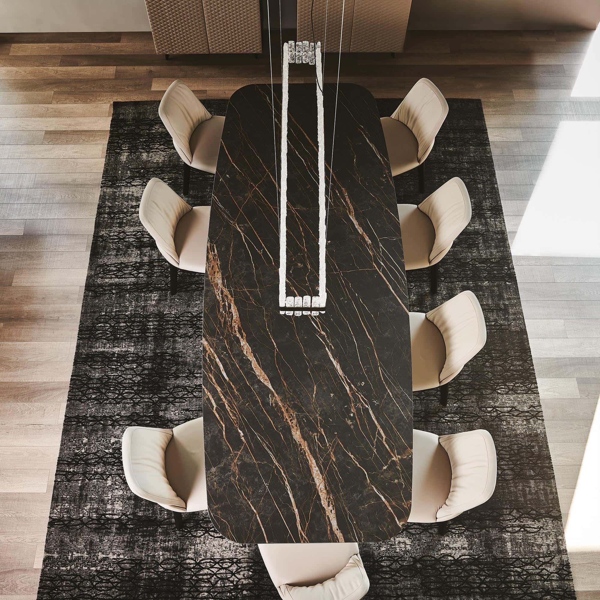 Skorpio Keramik dining table with light marble ceramic top styled with gold accents.