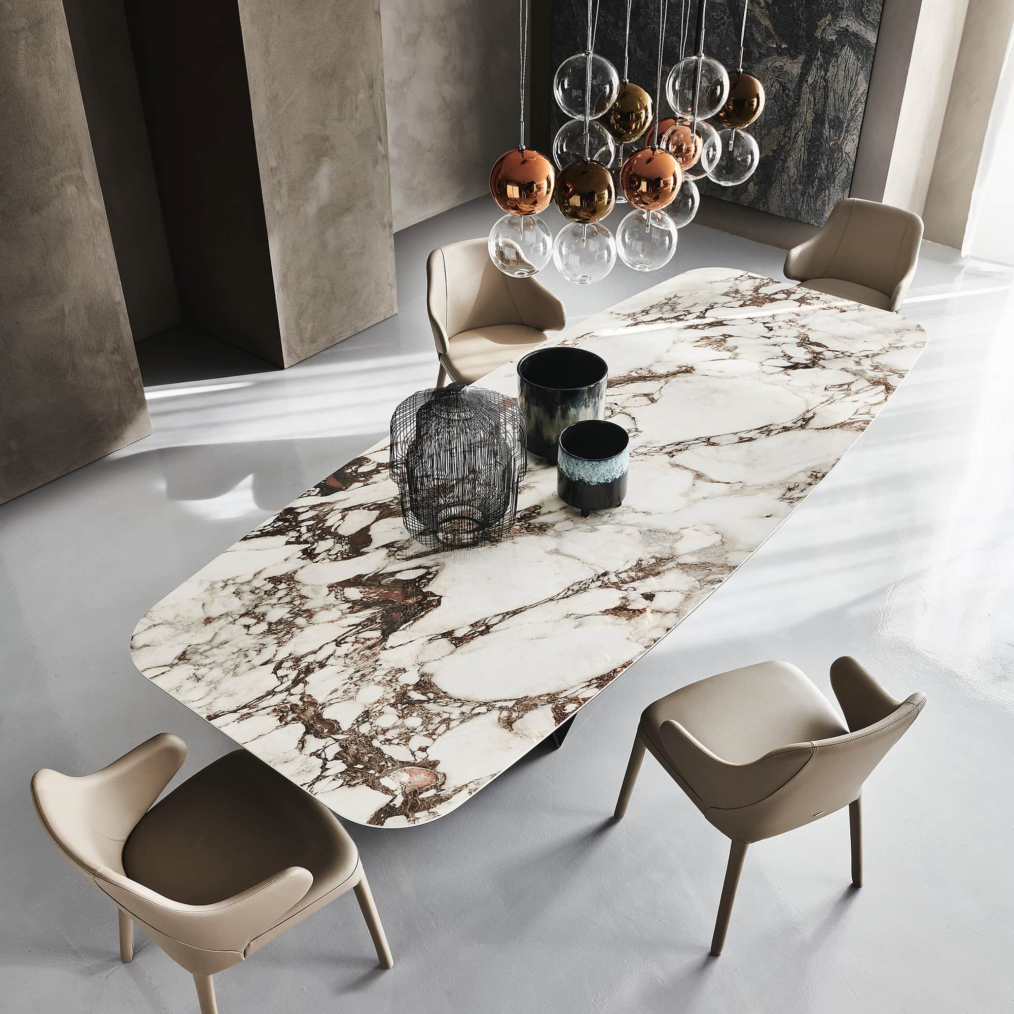 Skorpio Keramik dining table with dark ceramic top in a contemporary dining room setting.