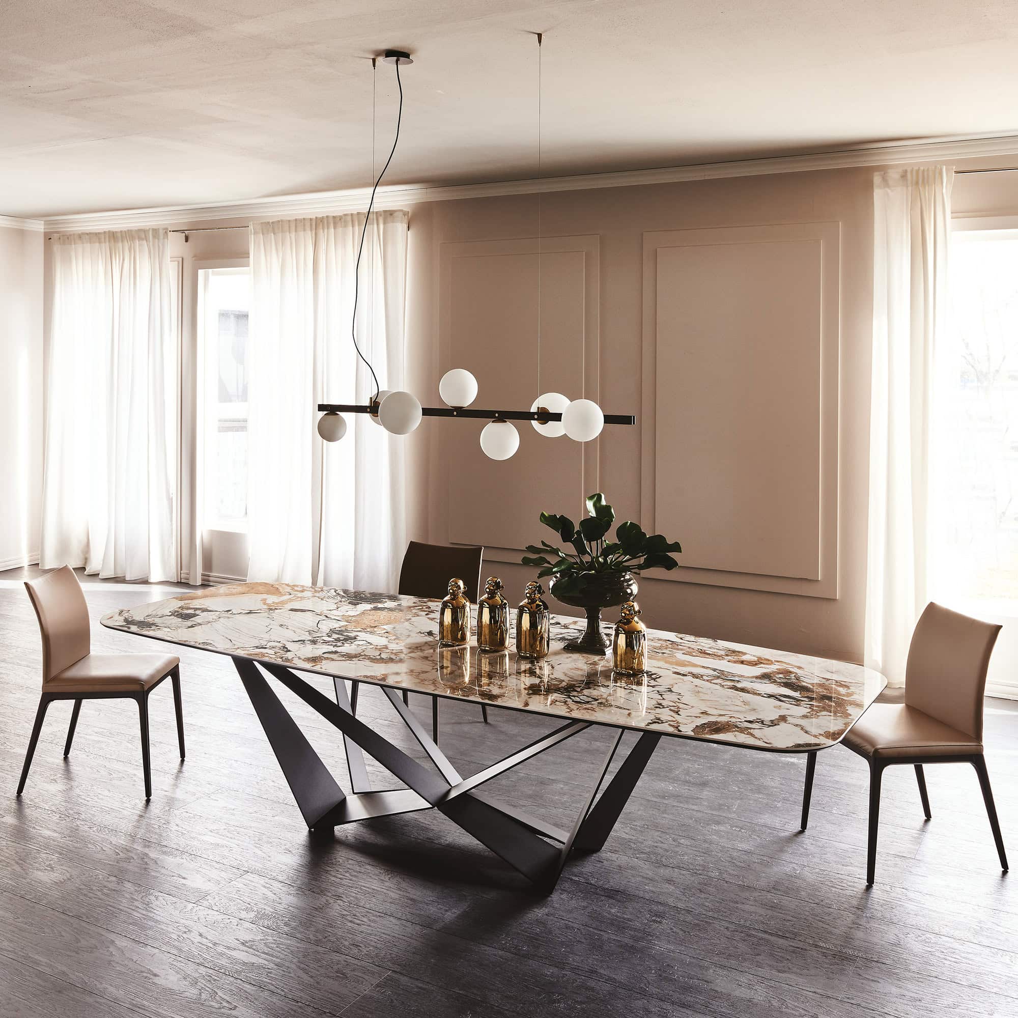 Skorpio Keramik dining table with black steel base and glossy ceramic top in a modern space.