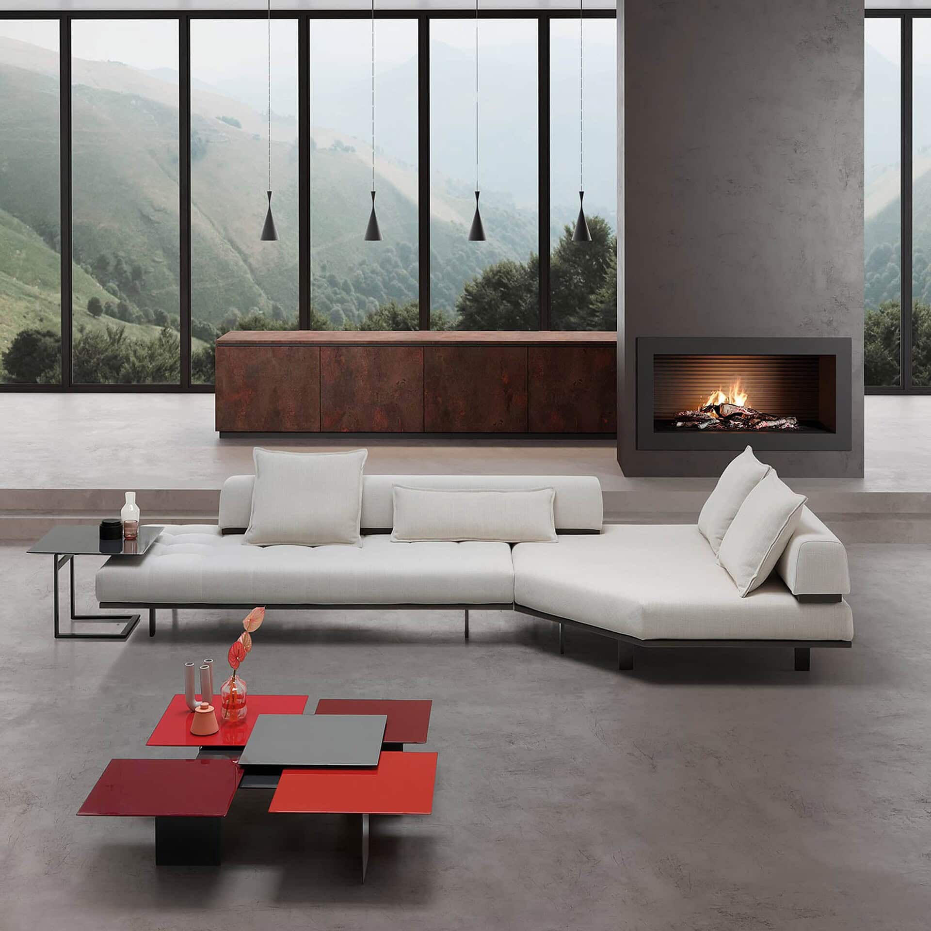 Contemporary living room with modern sectional sofa, minimalist coffee table, and fireplace, featuring floor-to-ceiling windows with mountain view.