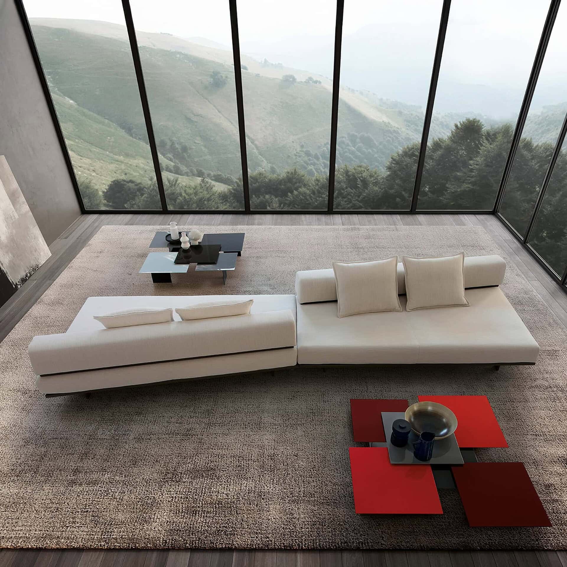 Contemporary white sectional sofa with throw pillows in a modern living room overlooking scenic mountains.