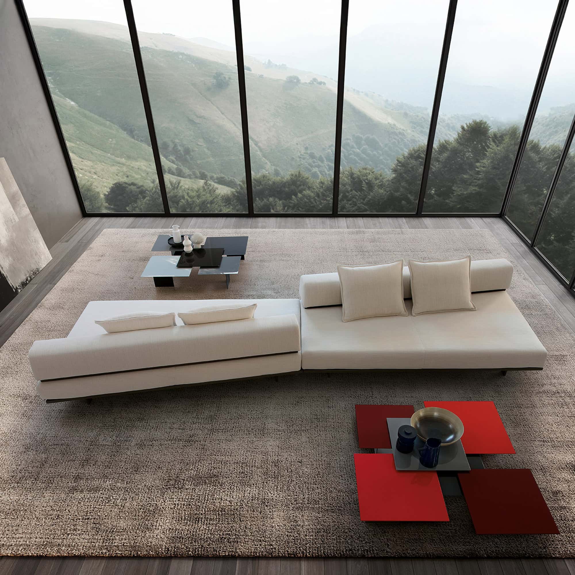 Contemporary white sectional sofa with throw pillows in a modern living room overlooking scenic mountains.