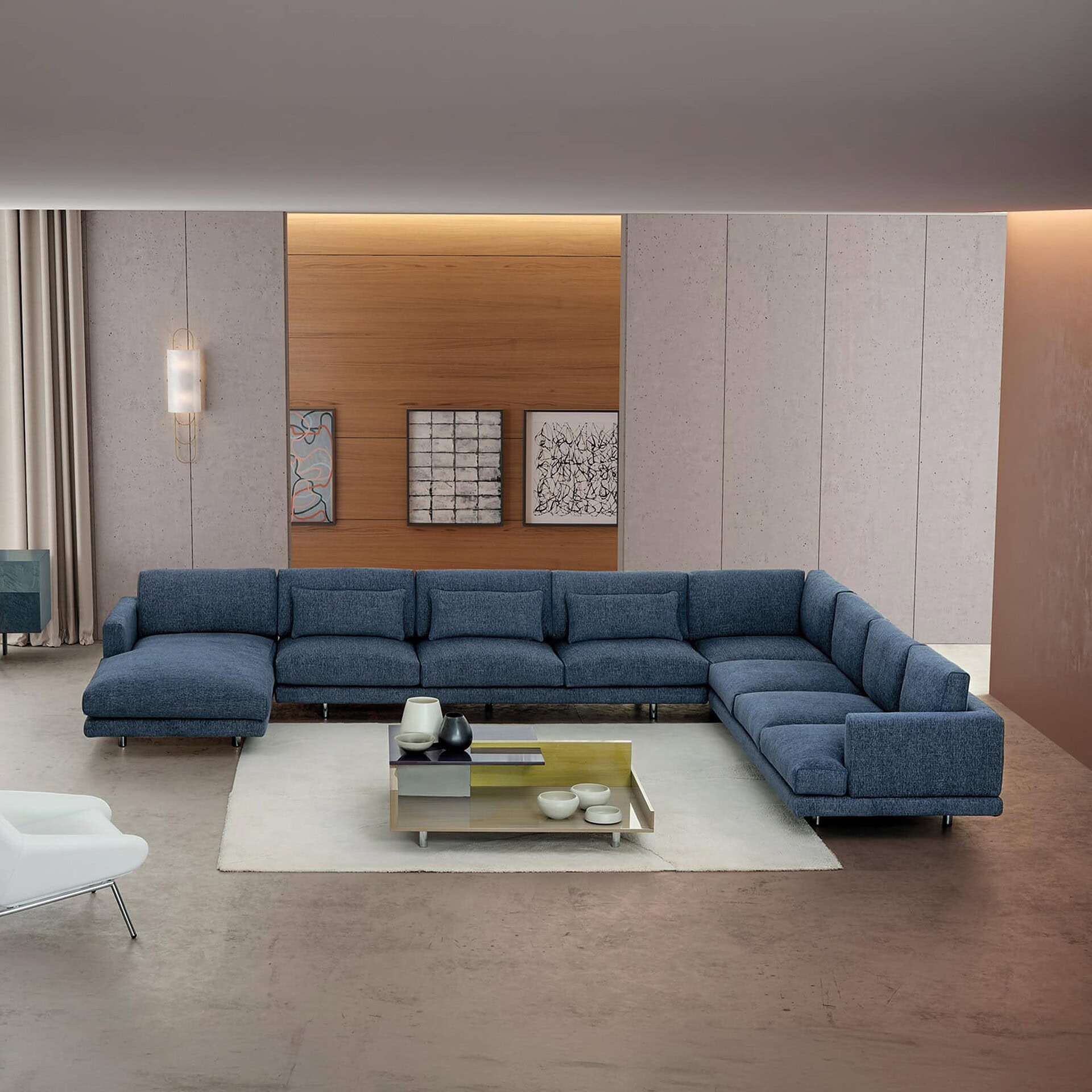 Luxurious modern sectional sofa in deep blue fabric in a contemporary living room setting.