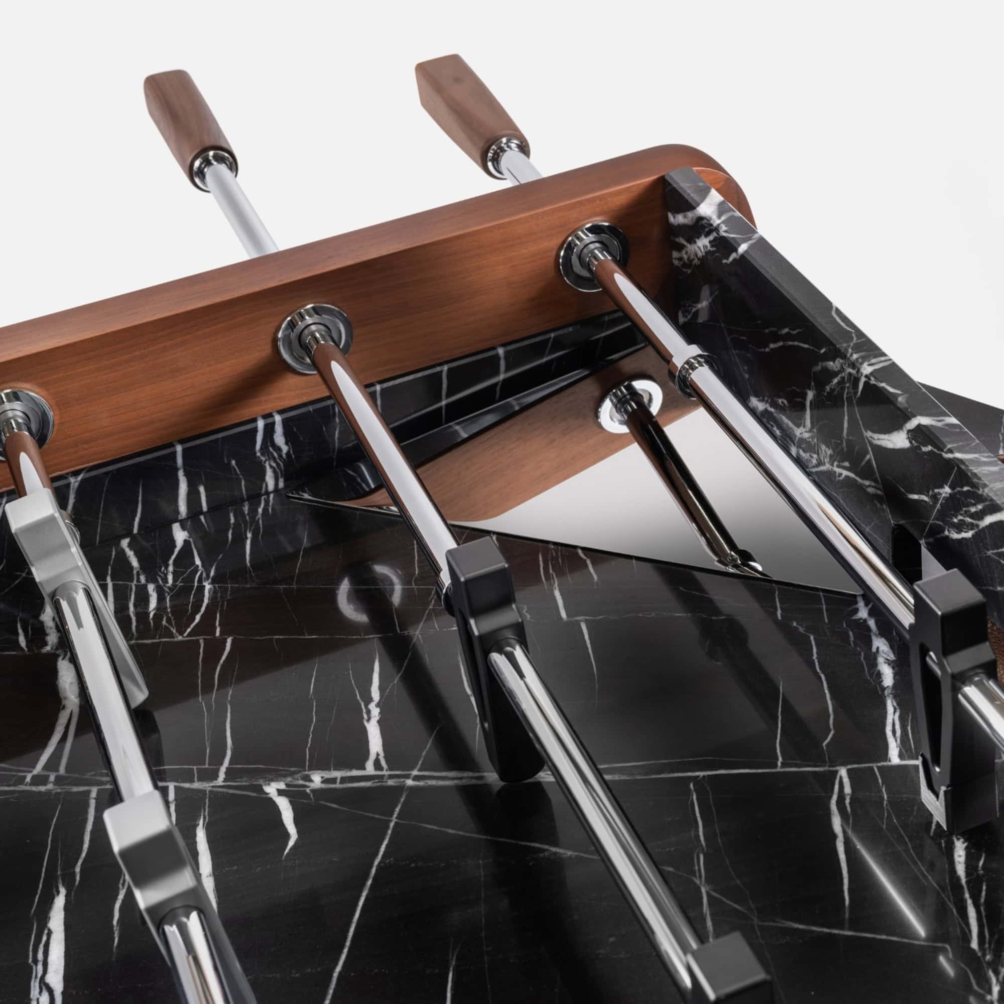 Sleek black marble coffee table with wooden accents and chrome legs.
