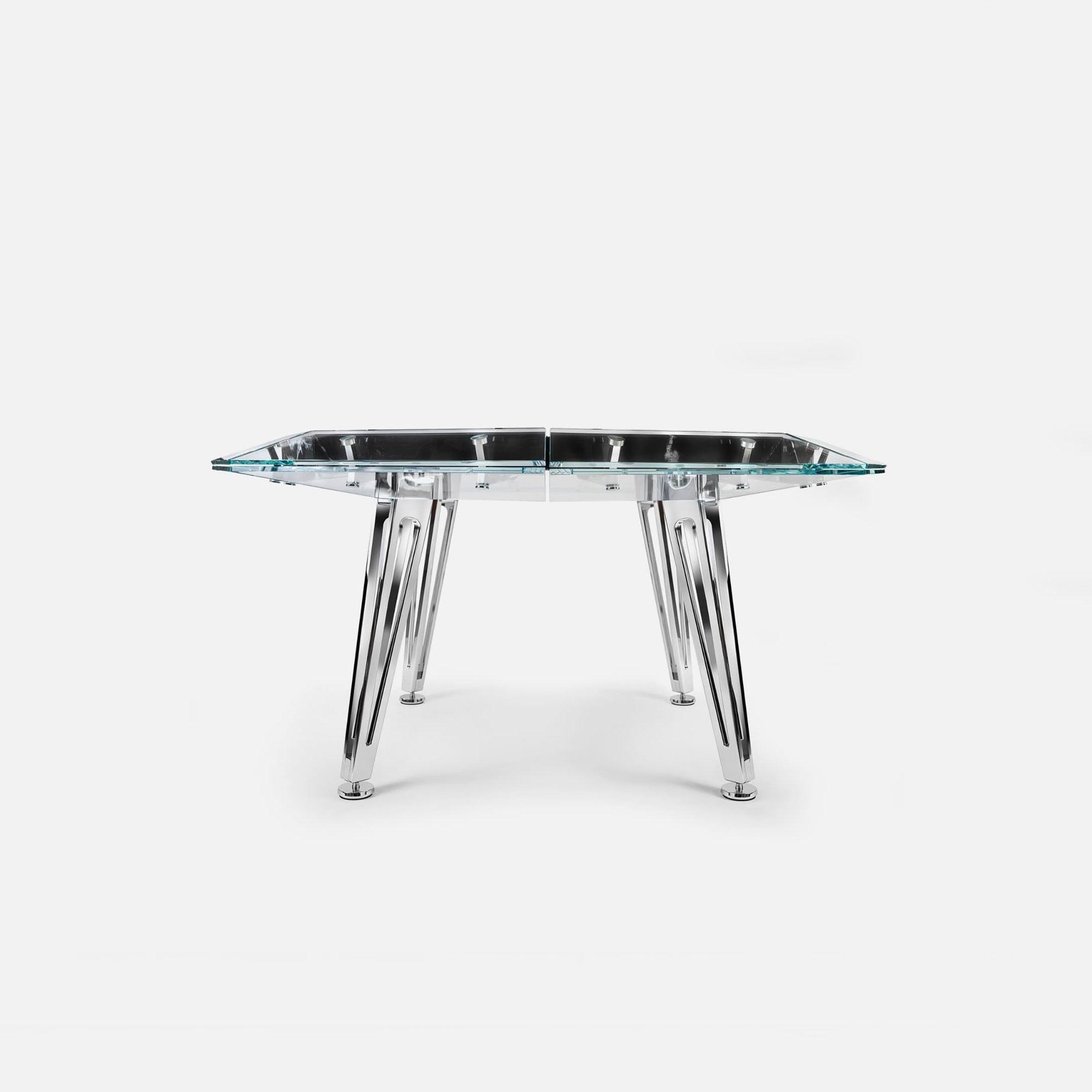 Sleek modern glass dining table with chrome legs, stylish and durable furniture design.