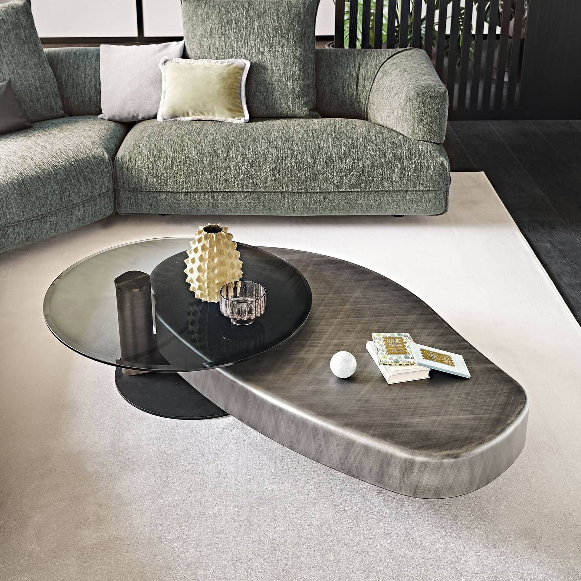 Arena Long Bond Coffee Table in a contemporary sectional setup with brushed bronze finish and layered design.