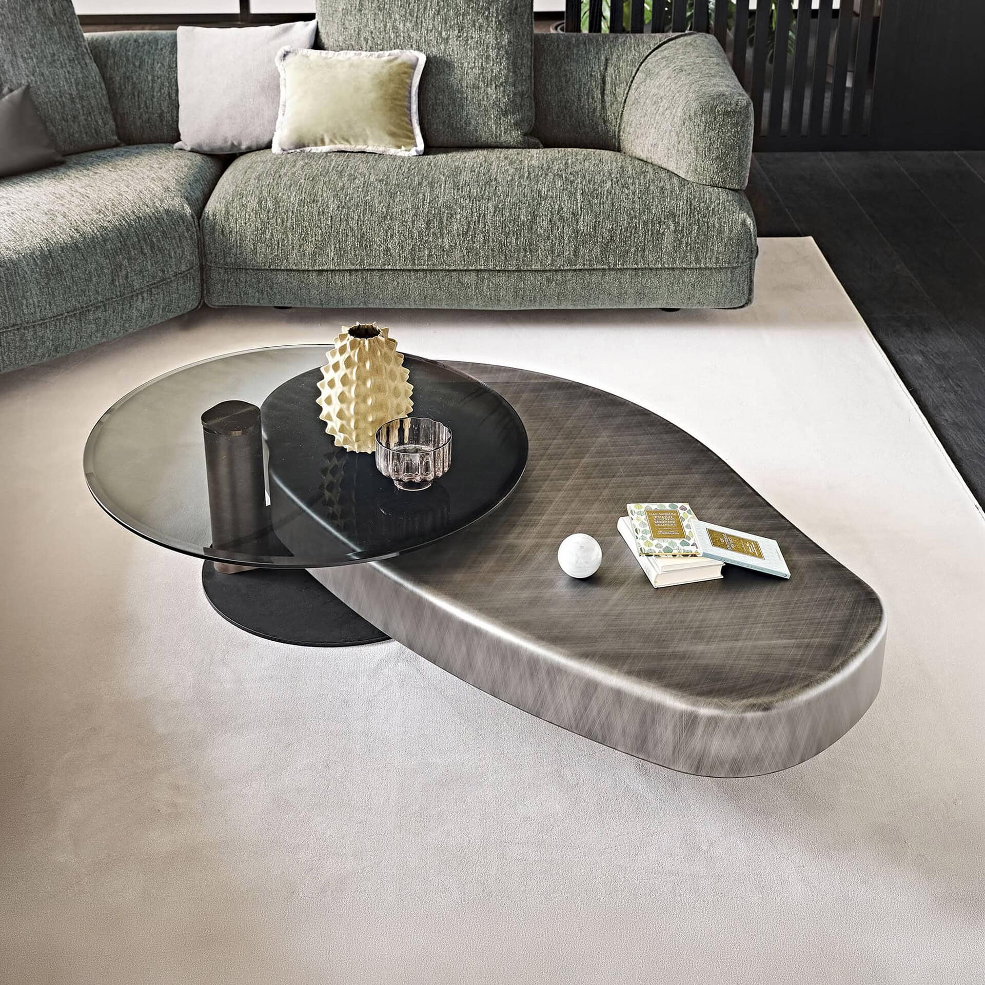 Sculptural coffee table with a unique, artistic design featuring a combination of glass and metal fi.