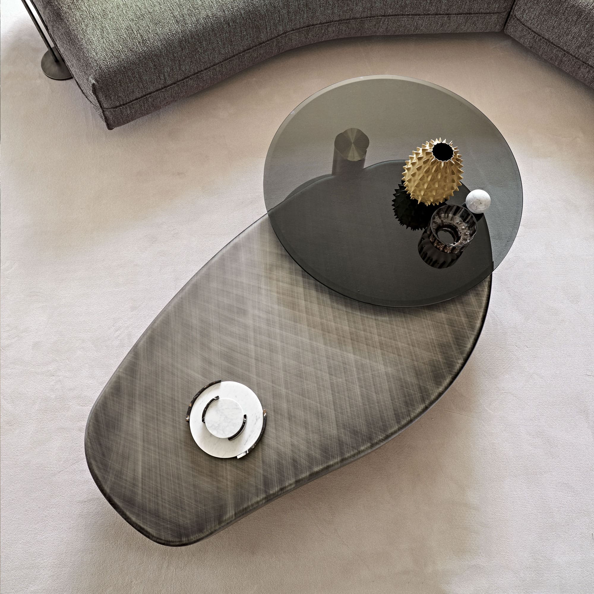 Overhead angled view of the Arena Long Coffee Table highlighting the beveled glass swivel top and brushed wood base.