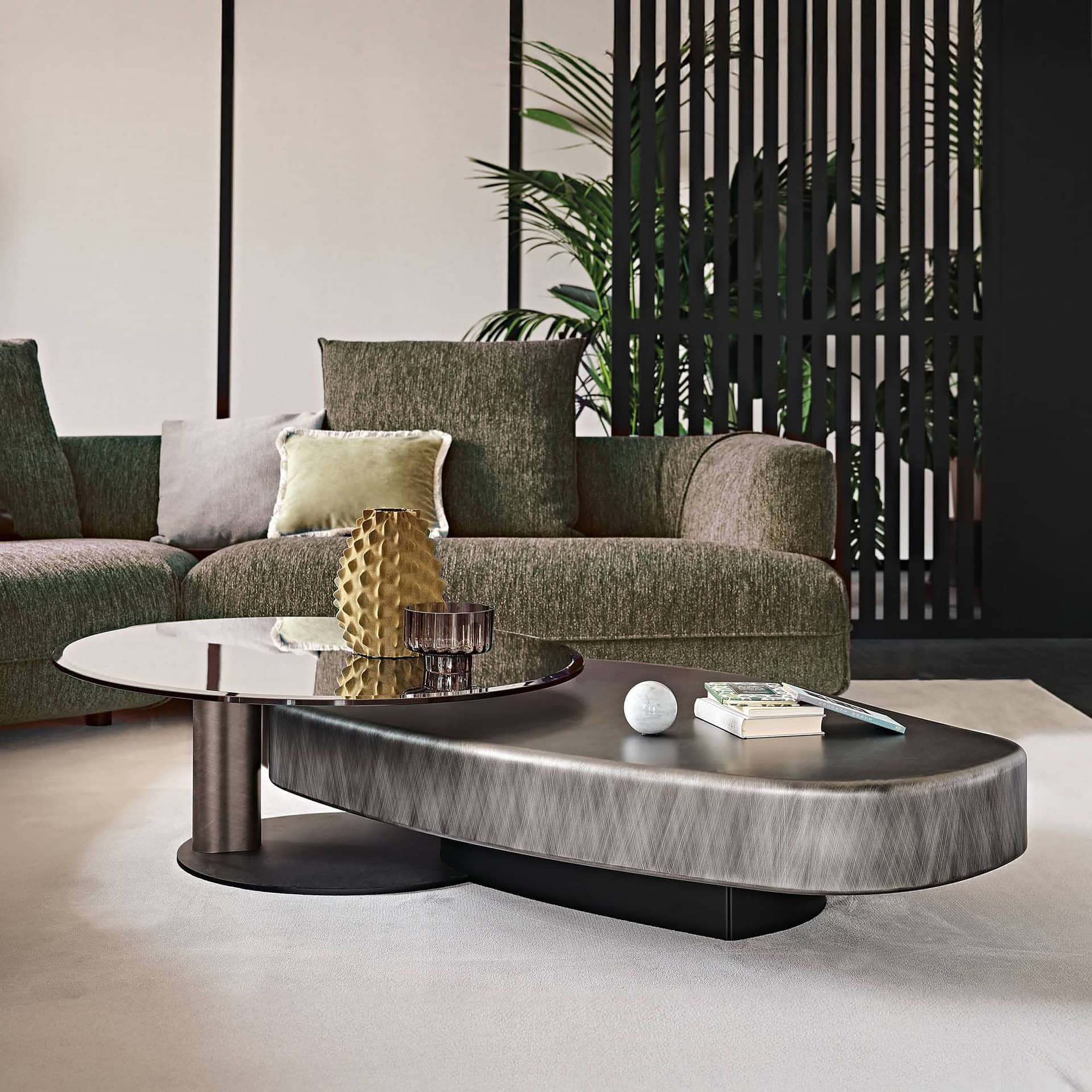 Arena Long Coffee Table with brushed grey wood base and bronze swivel glass top styled in a modern living room.