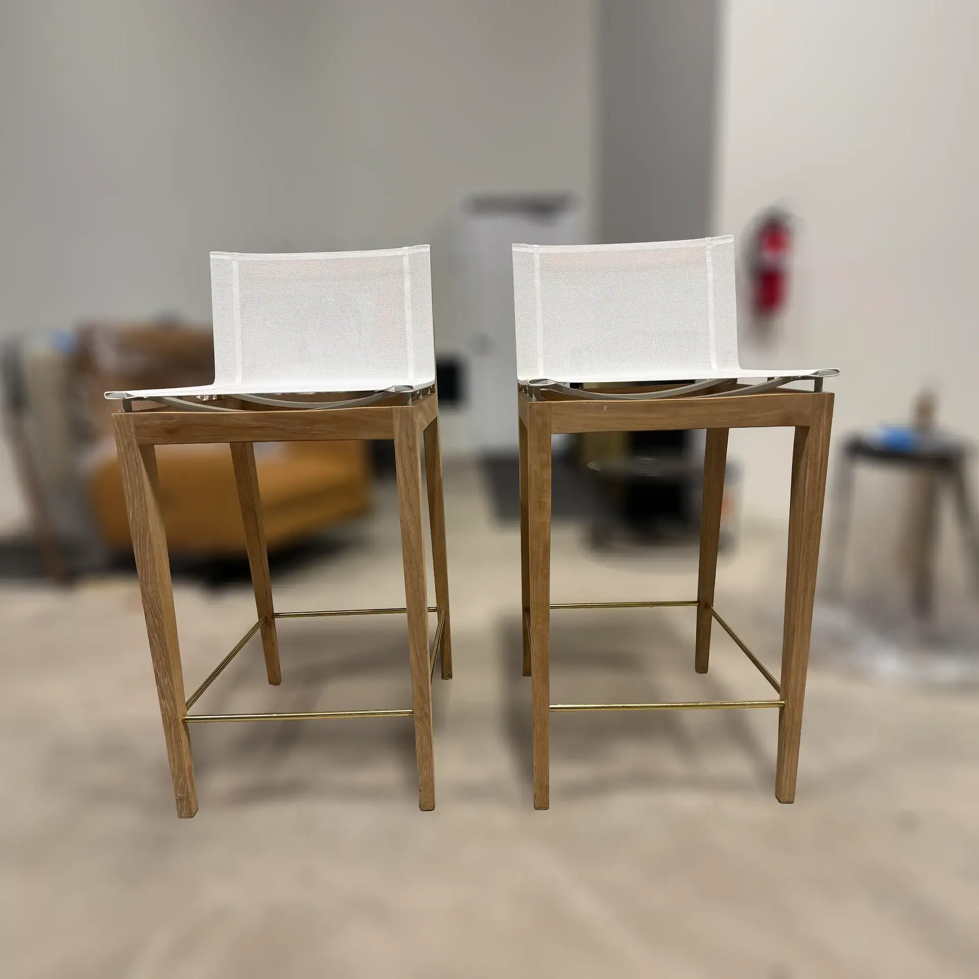 Harbour Byron outdoor bar stools with white seats and wooden frames.
