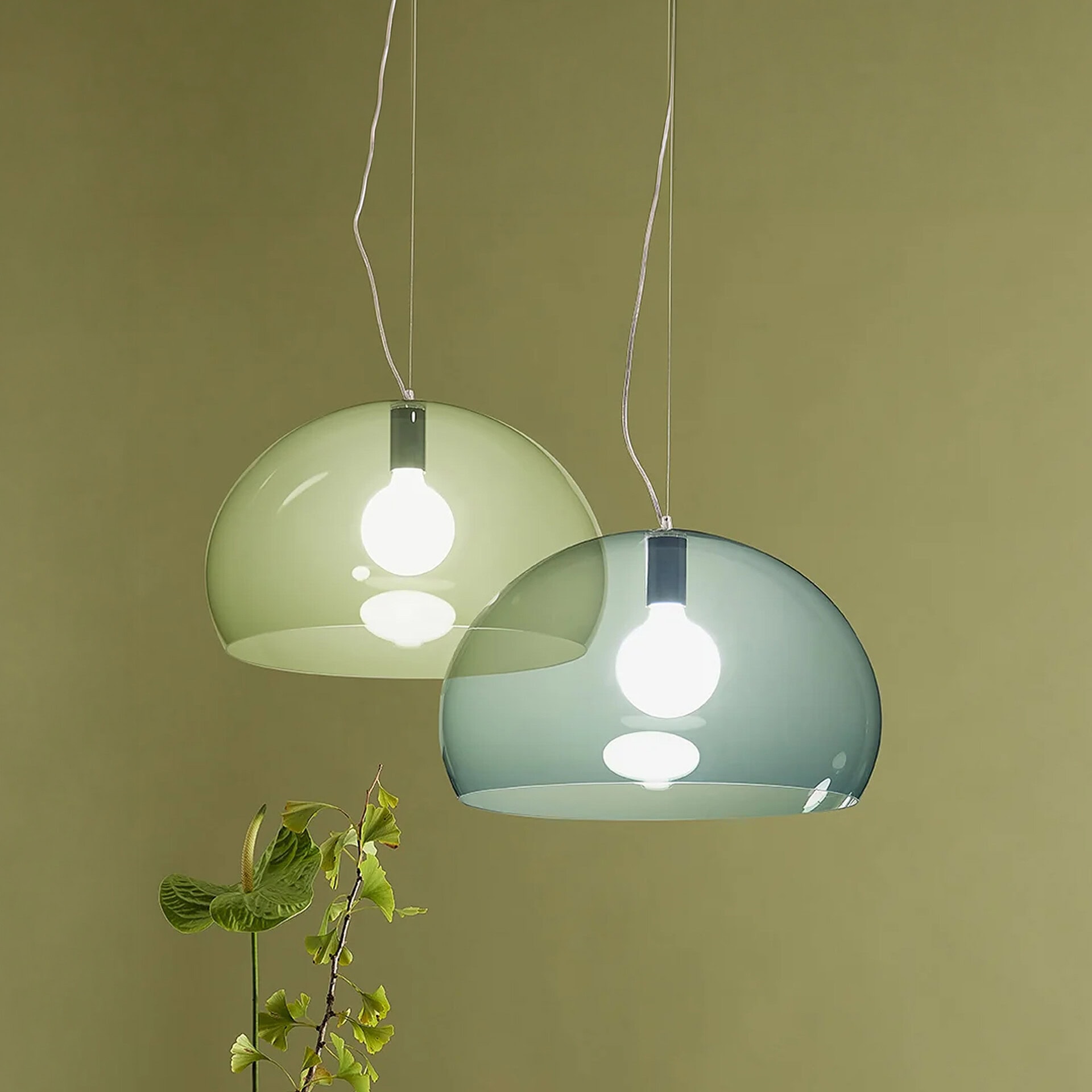 Pendant light fixtures with sleek, contemporary design in green and blue shades.