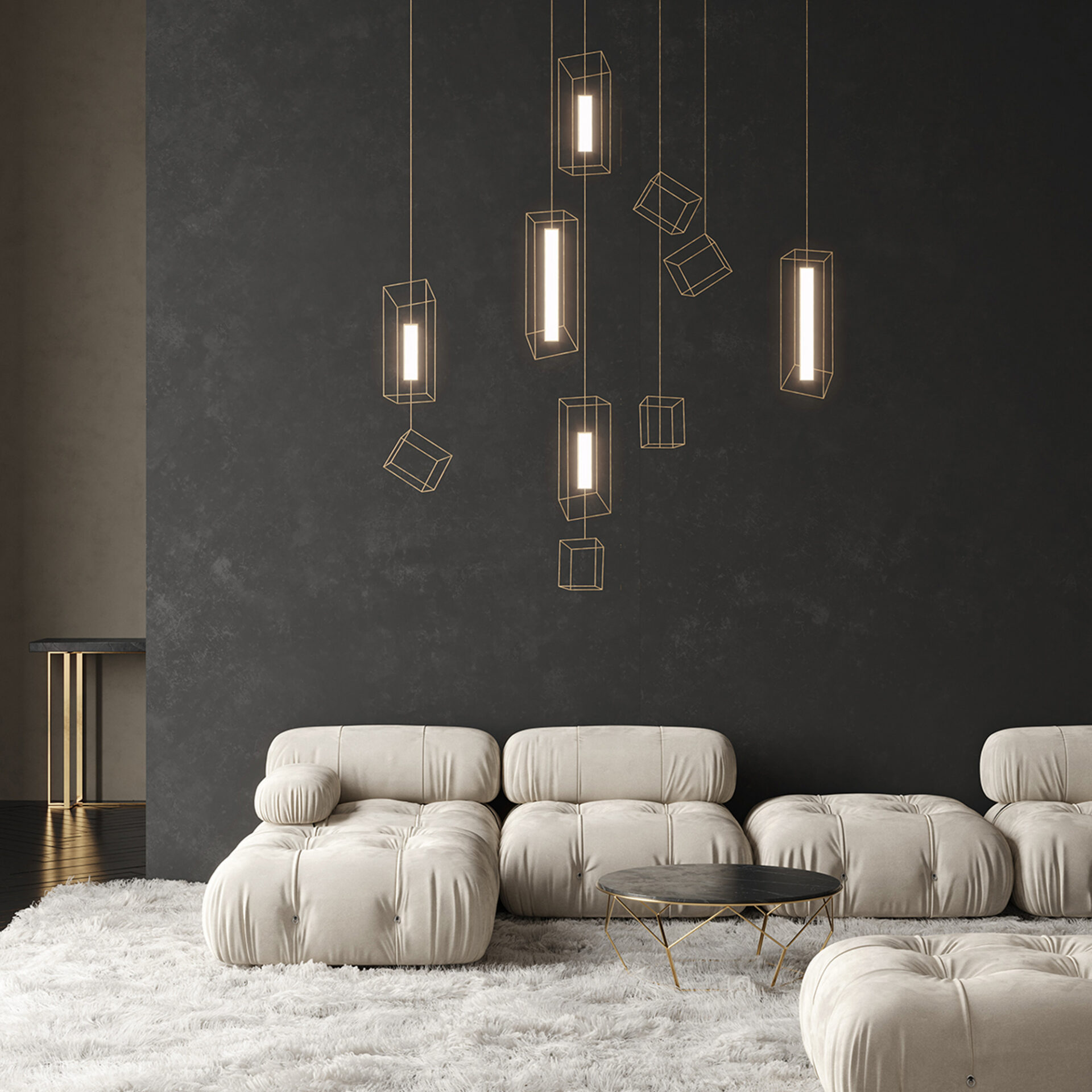 A modern living room with a large, off-white modular sofa on a shaggy cream rug. Geometric gold pendant lights hang from the ceiling against a dark gray textured wall. A round black marble coffee table sits in front of the sofa.