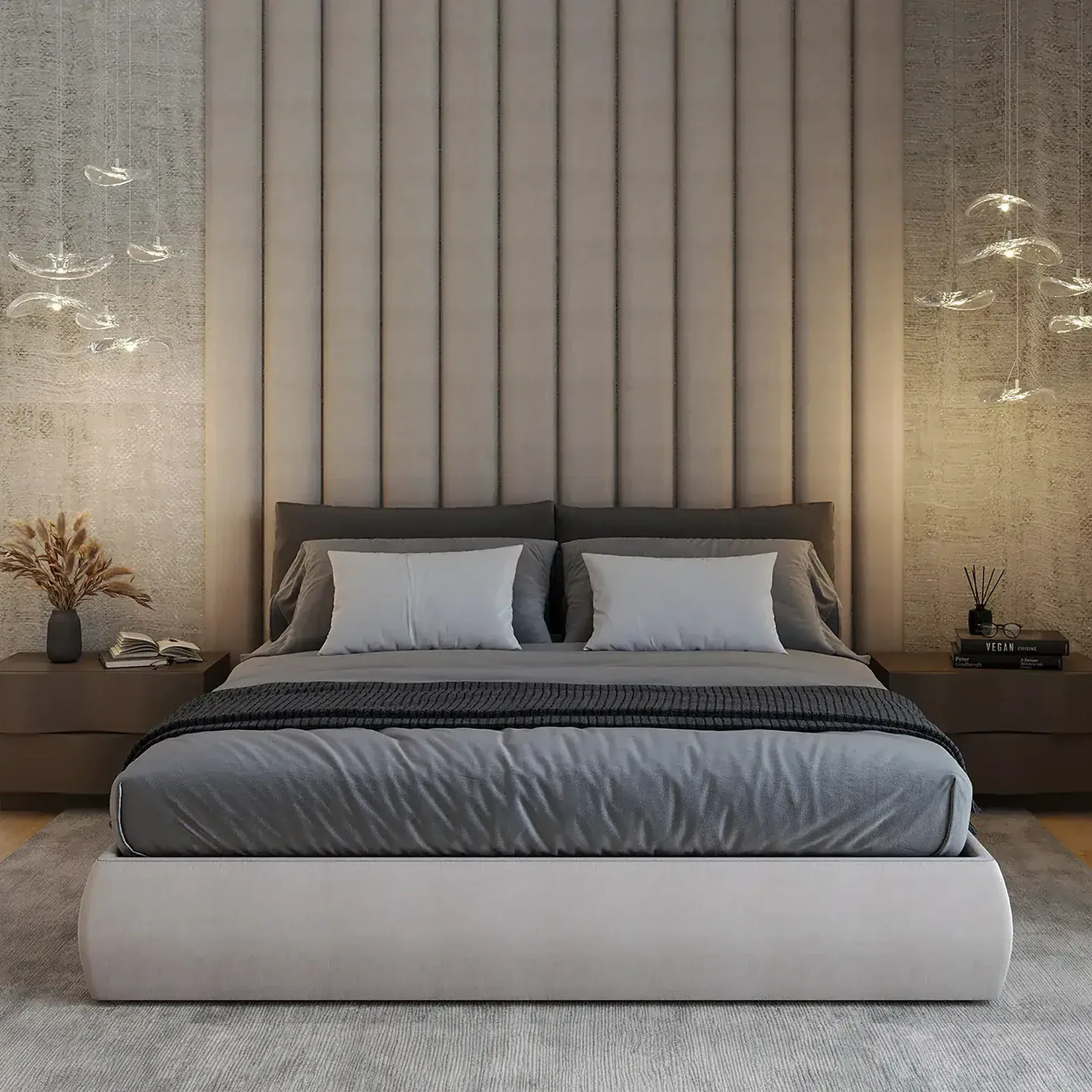 A modern bedroom with a large bed, padded headboard, dark wood nightstands, and unique glass pendant lights. A window shows green foliage outside.