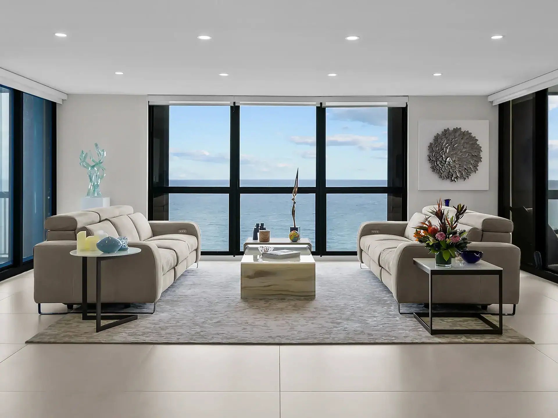 Contemporary living room with ocean view, stylish sofas, and modern decor.