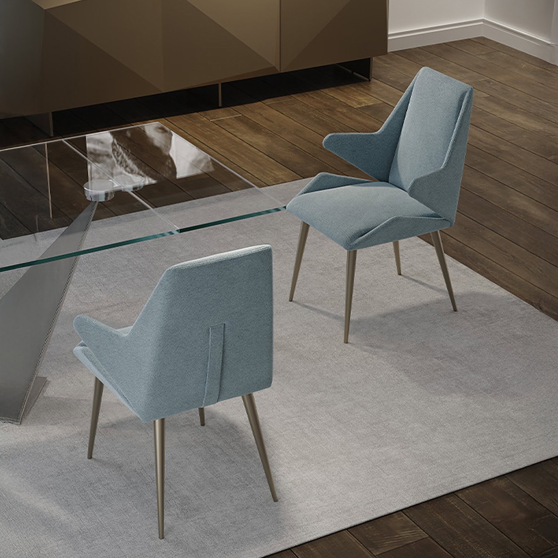 Origami Upholstered Dining Chairs in a modern dining space, upholstered in blue fabric with angled legs.
