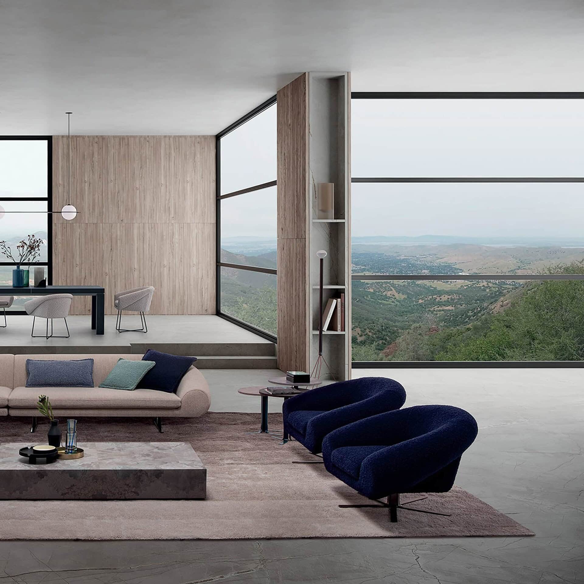 Pair of Airstrike Swivel Armchairs in navy blue arranged in a refined modern seating area.