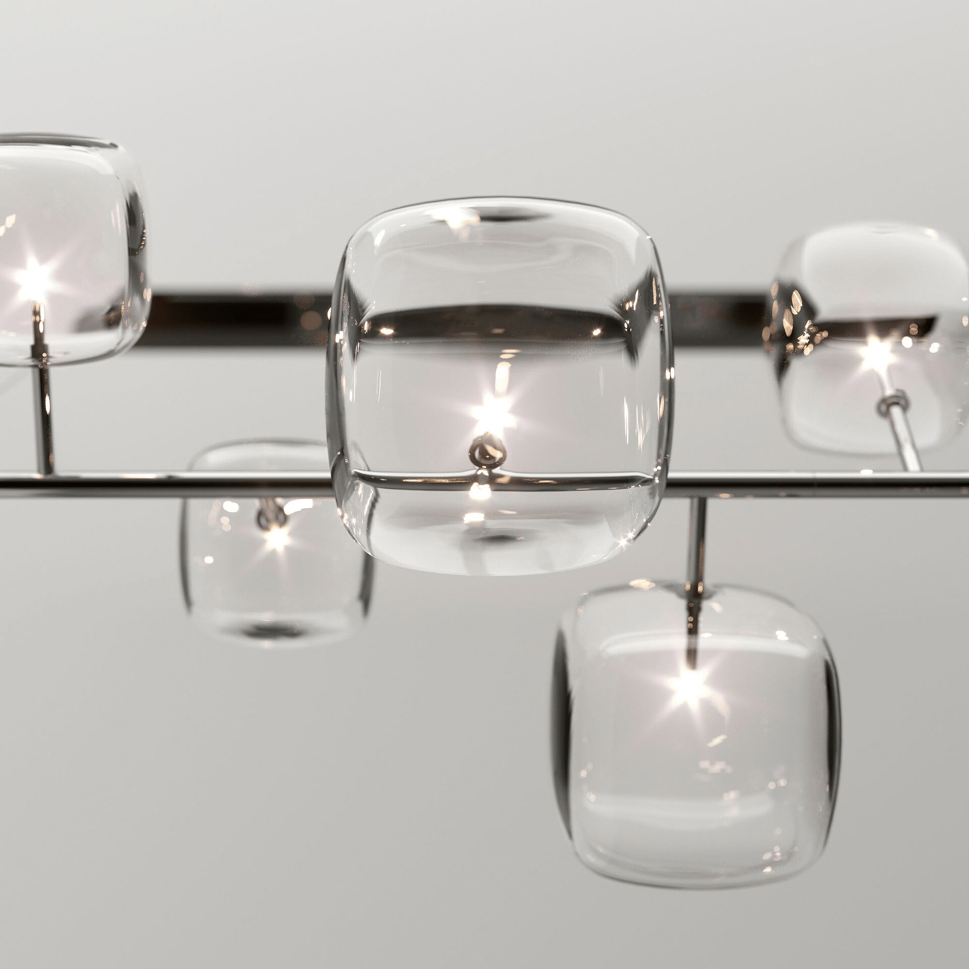 Pendant light with clear glass shades and sleek metal accents.