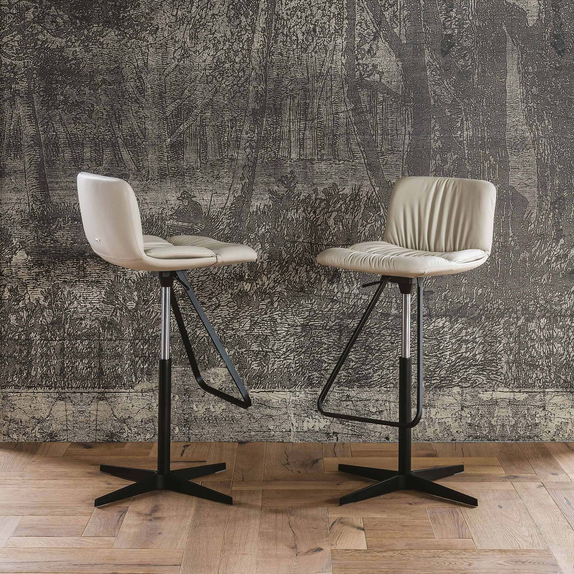 Axel Adjustable Swivel Bar Stool in front of a wall
