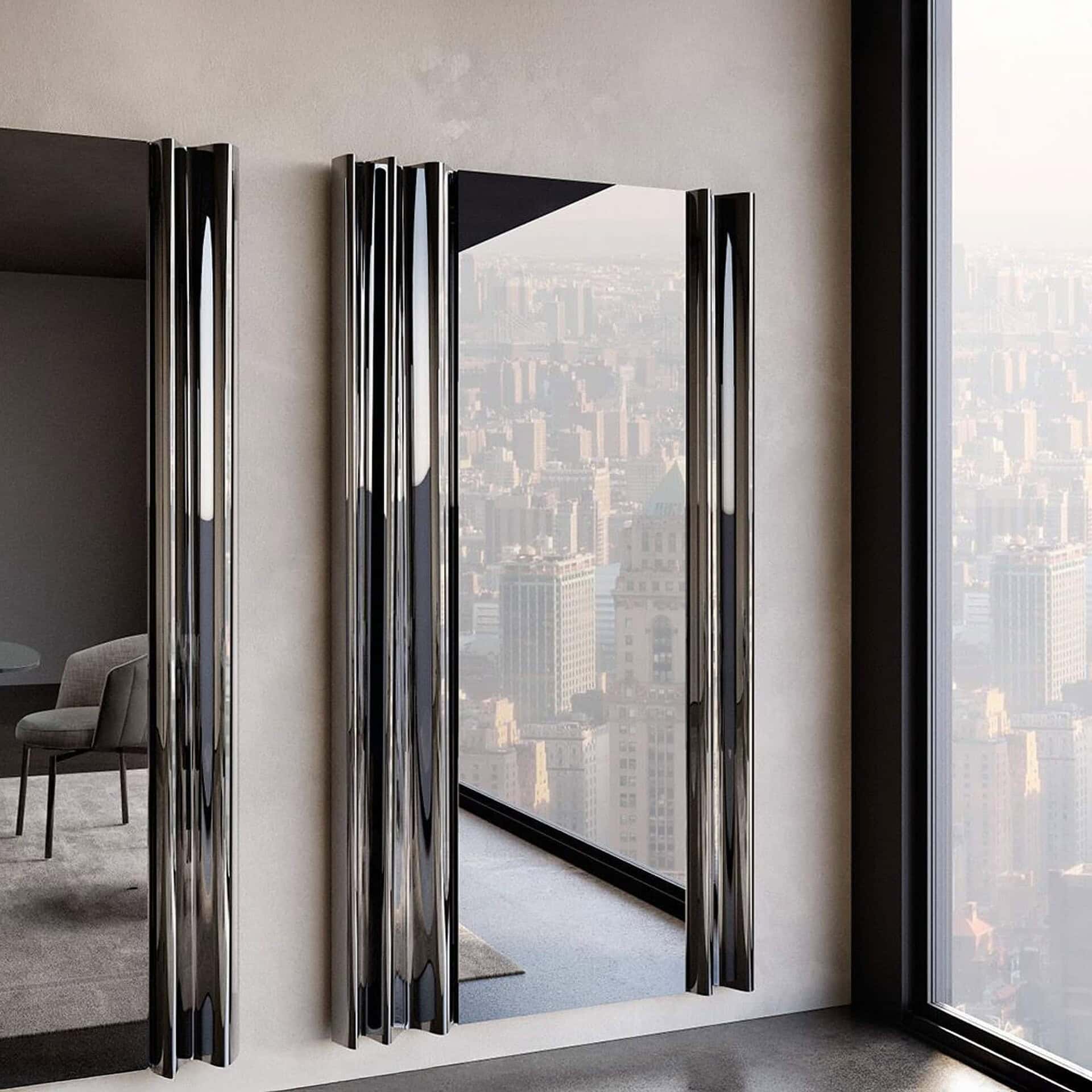 Angled view of Eforma Rolli Vertical Mirror with smoked mirrored glass, showcasing sculptural layered glass effect.