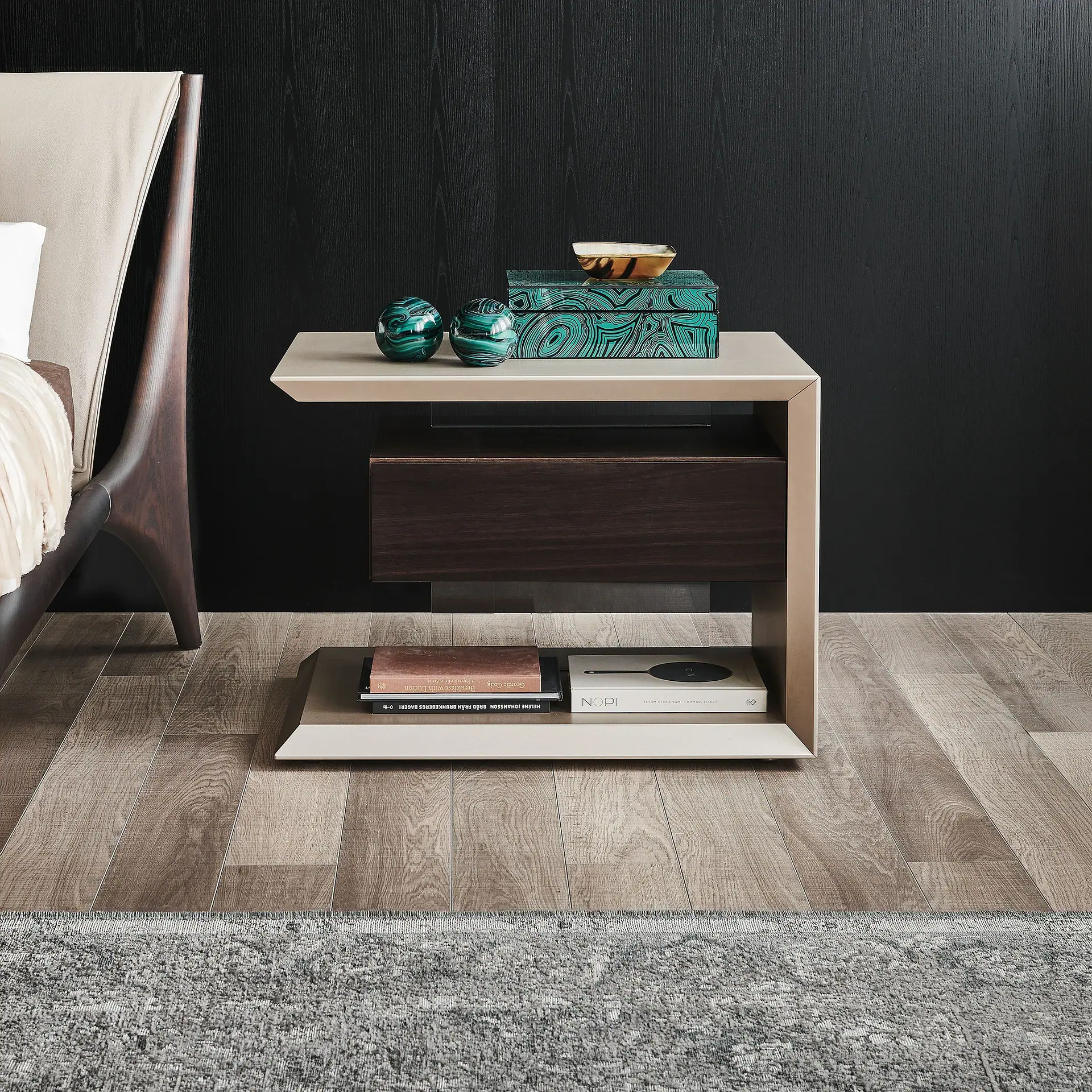 Contemporary nightstand with storage and decorative accents in a modern bedroom setting.