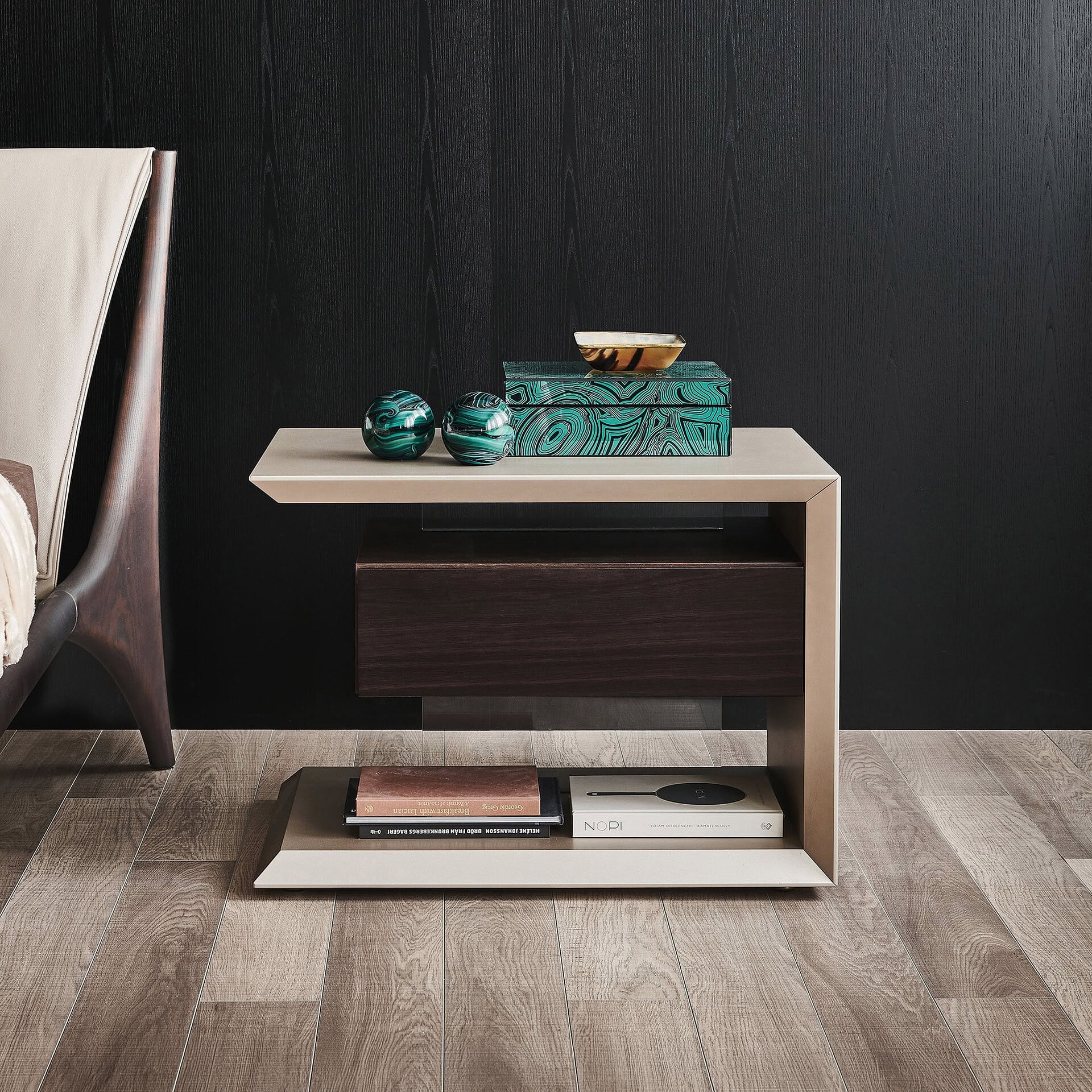 Contemporary nightstand with storage and decorative accents in a modern bedroom setting.