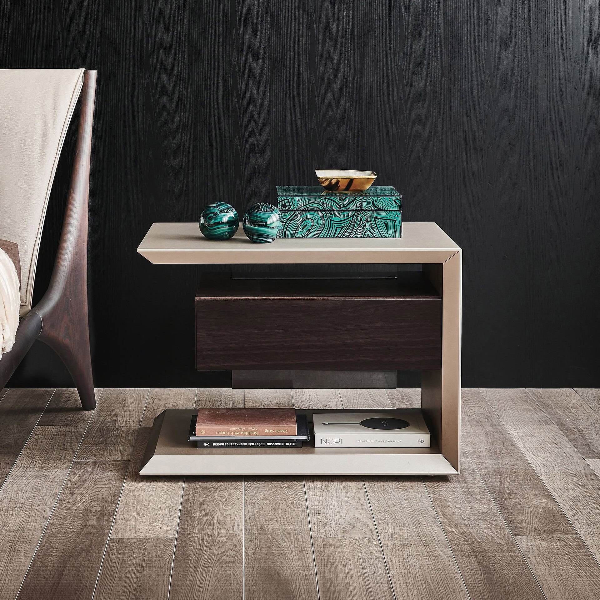 Contemporary nightstand with storage and decorative accents in a modern bedroom setting.
