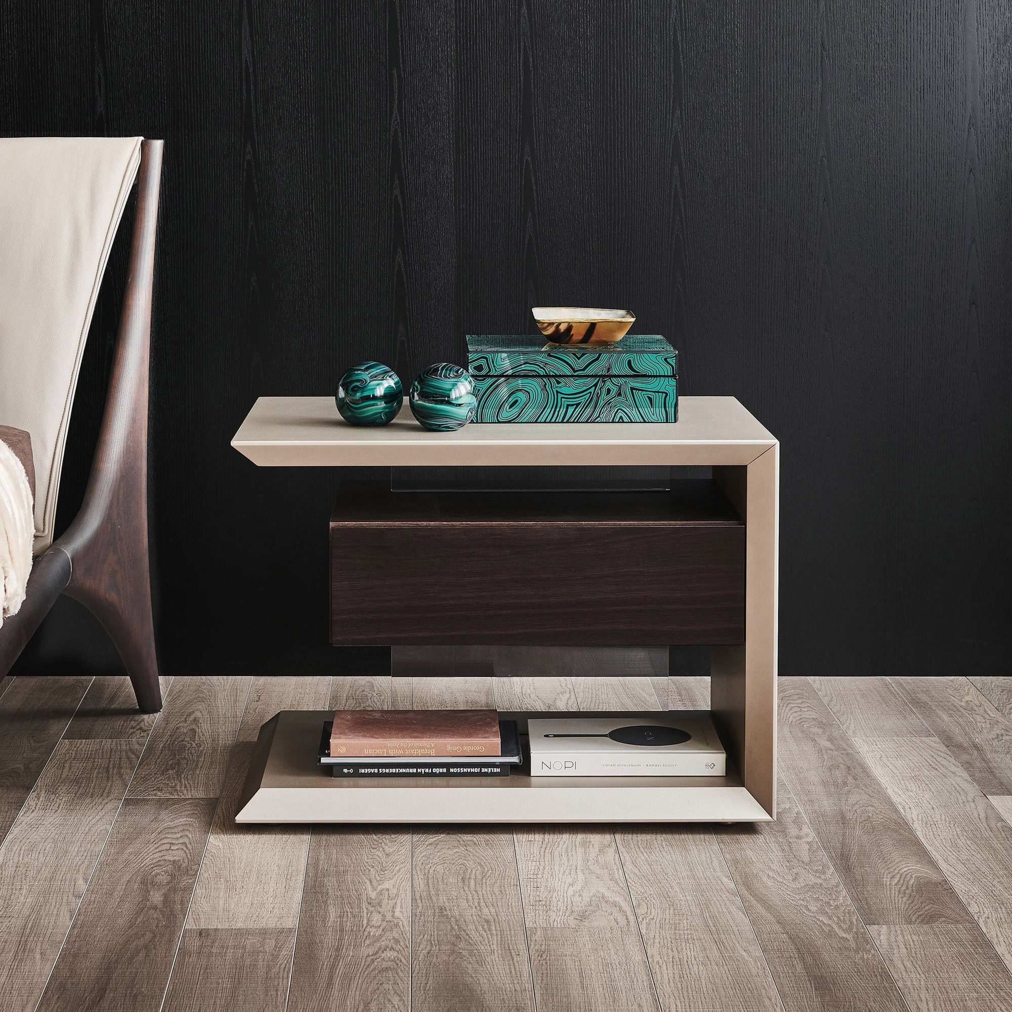 Contemporary nightstand with storage and decorative accents in a modern bedroom setting.