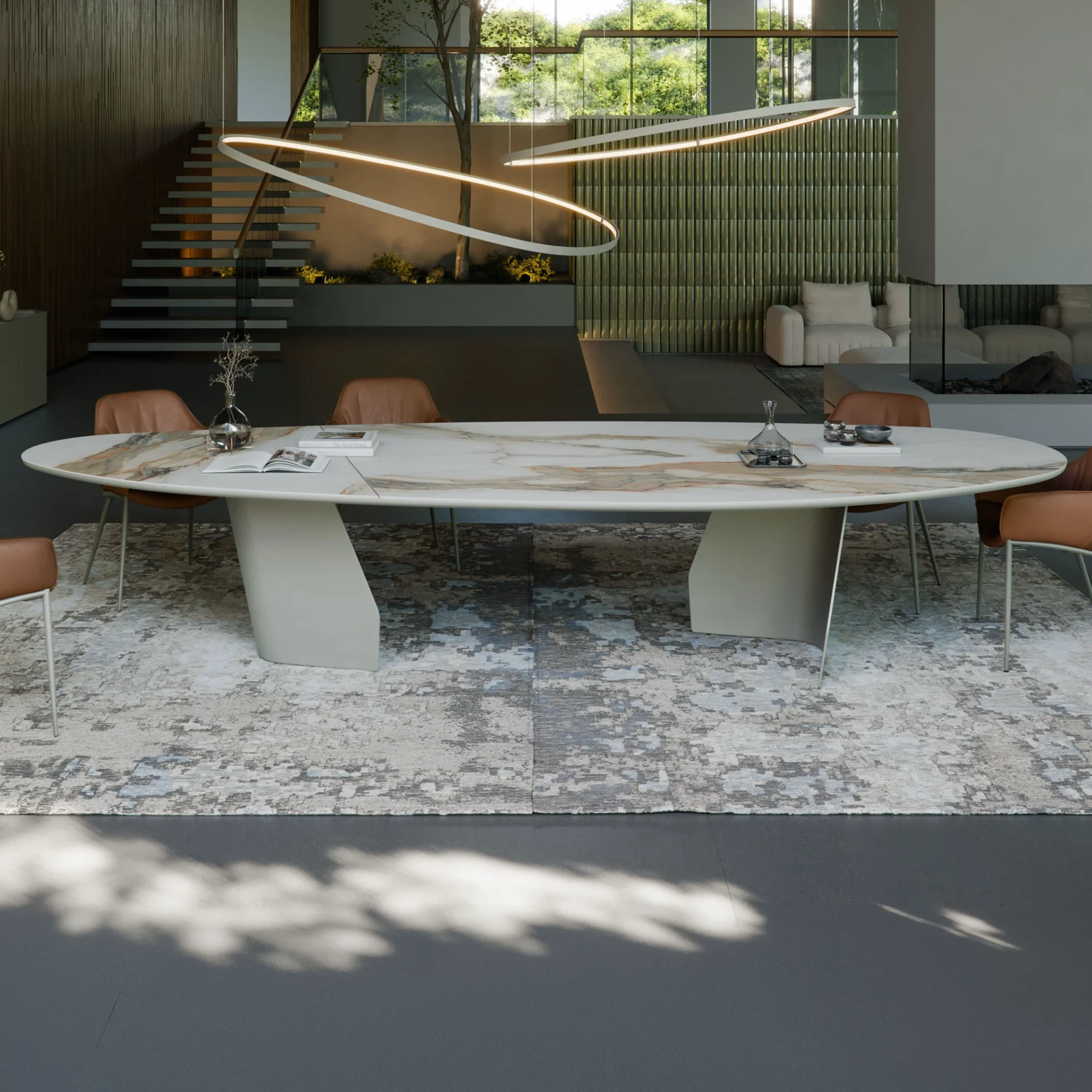 A modern, luxurious open-plan dining and living room with an oval marble dining table, brown leather chairs, a unique ring chandelier, a floating staircase, and large windows overlooking greenery.