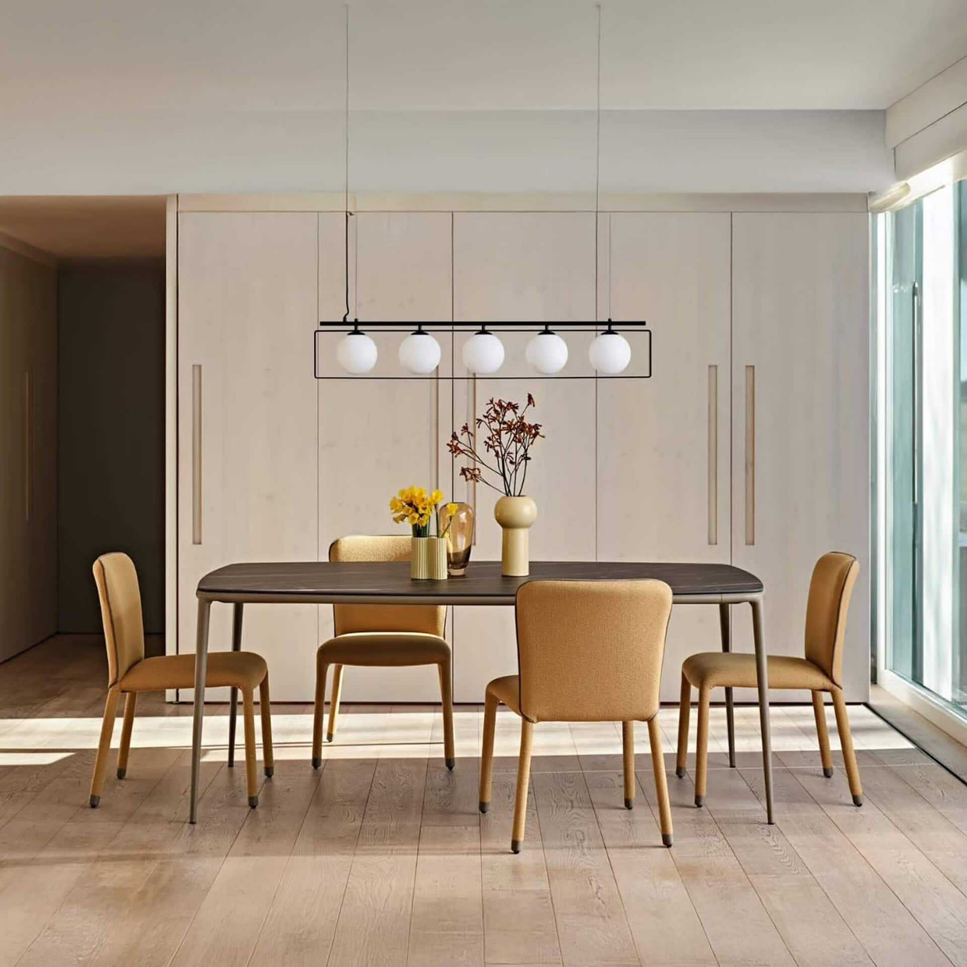 Dining room setting with six mustard-upholstered S1 Dining Chairs around a modern rectangular dining table.