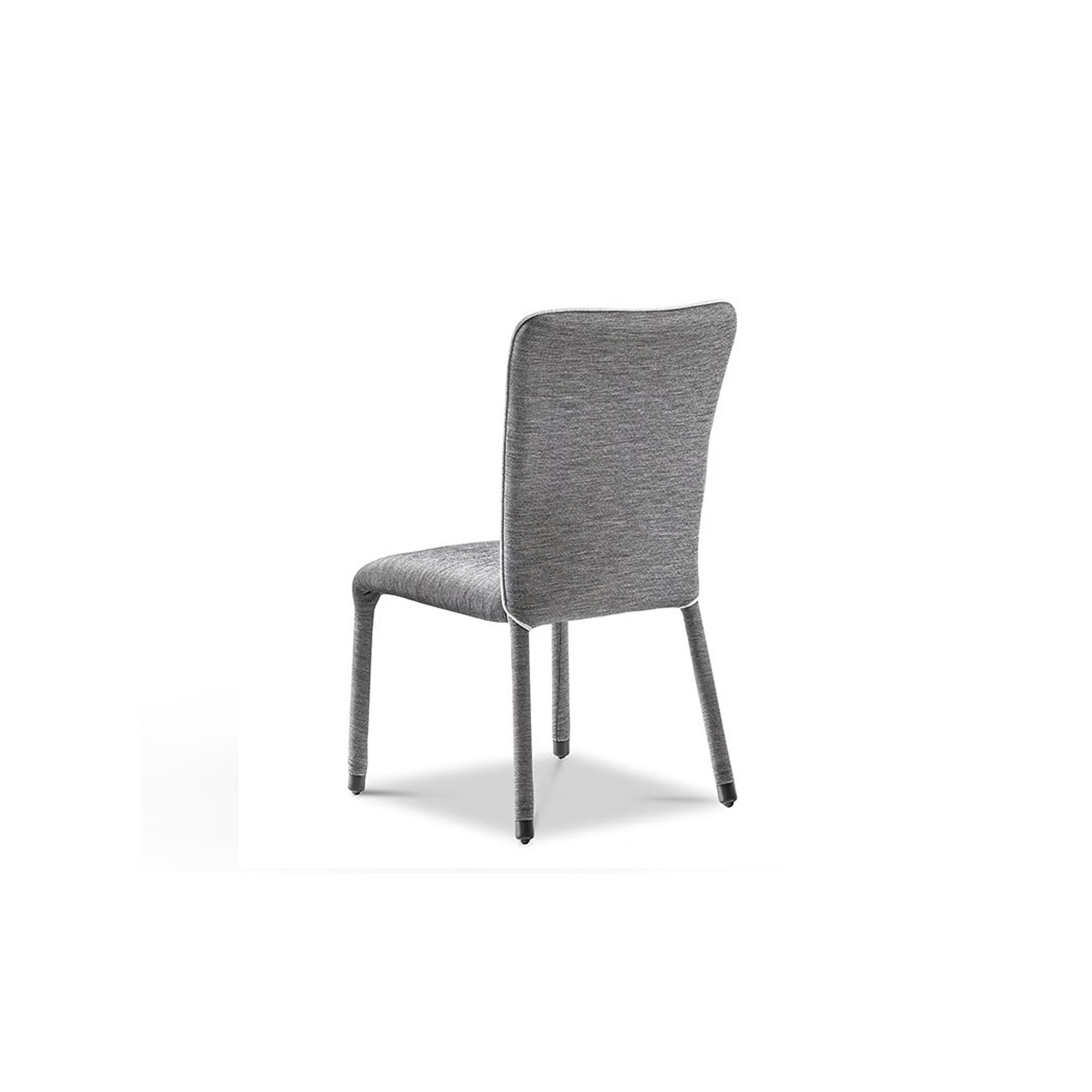 Rear angled view of an S1 Dining Chair in gray fabric upholstery.