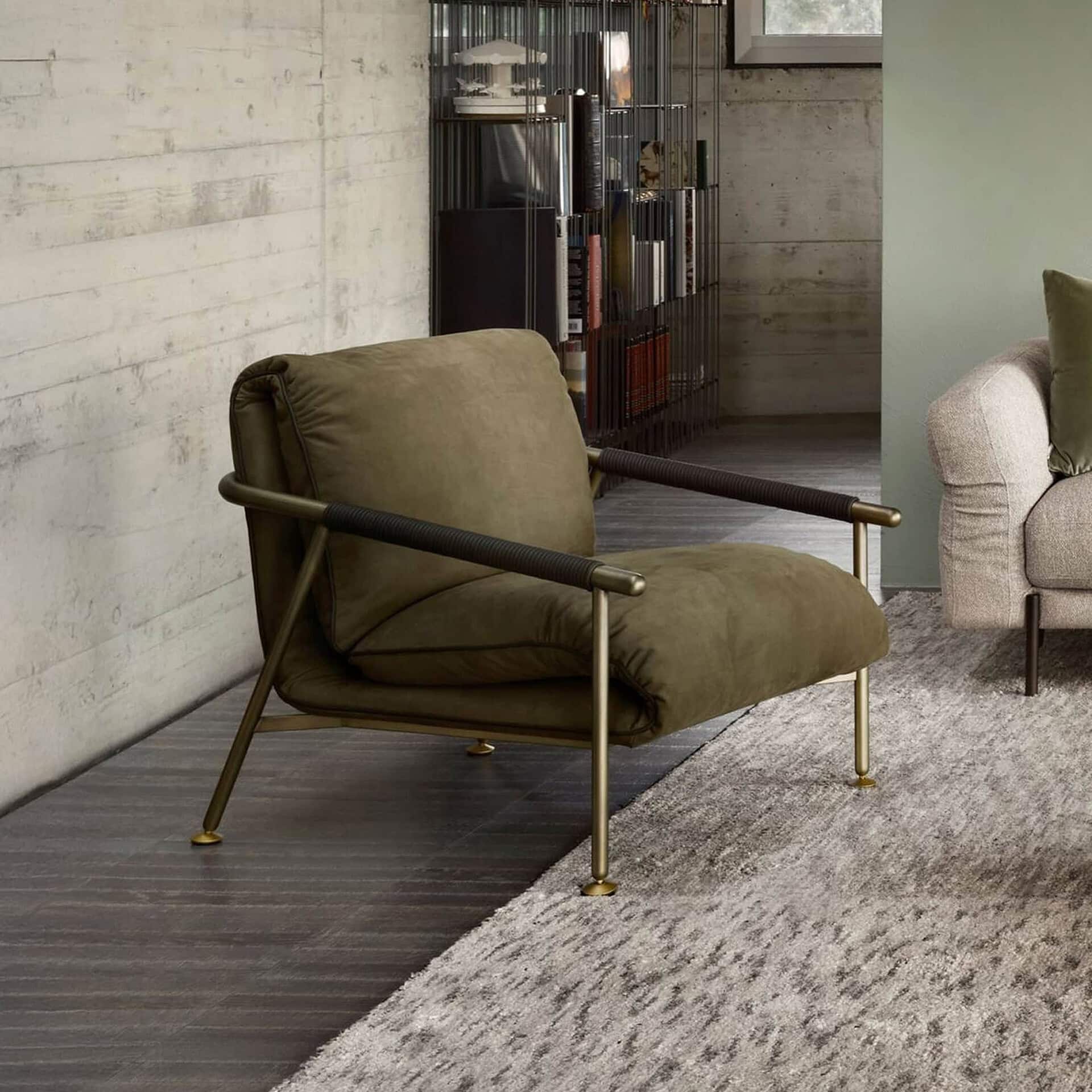 Upholstered Nicole lounge chair with sleek metal frame in a modern living room setting.