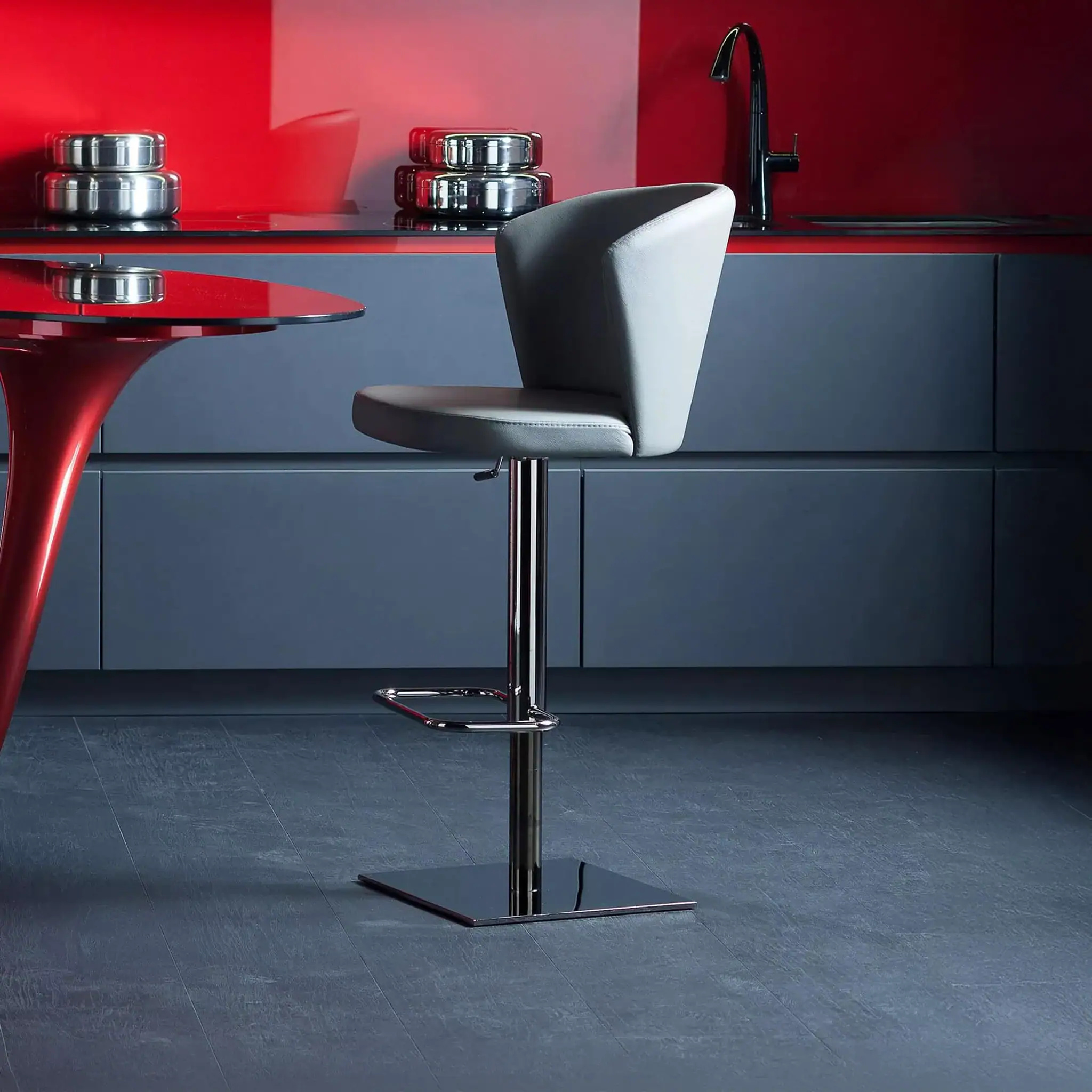 Contemporary kitchen bar stool with black and white upholstery and chrome base.