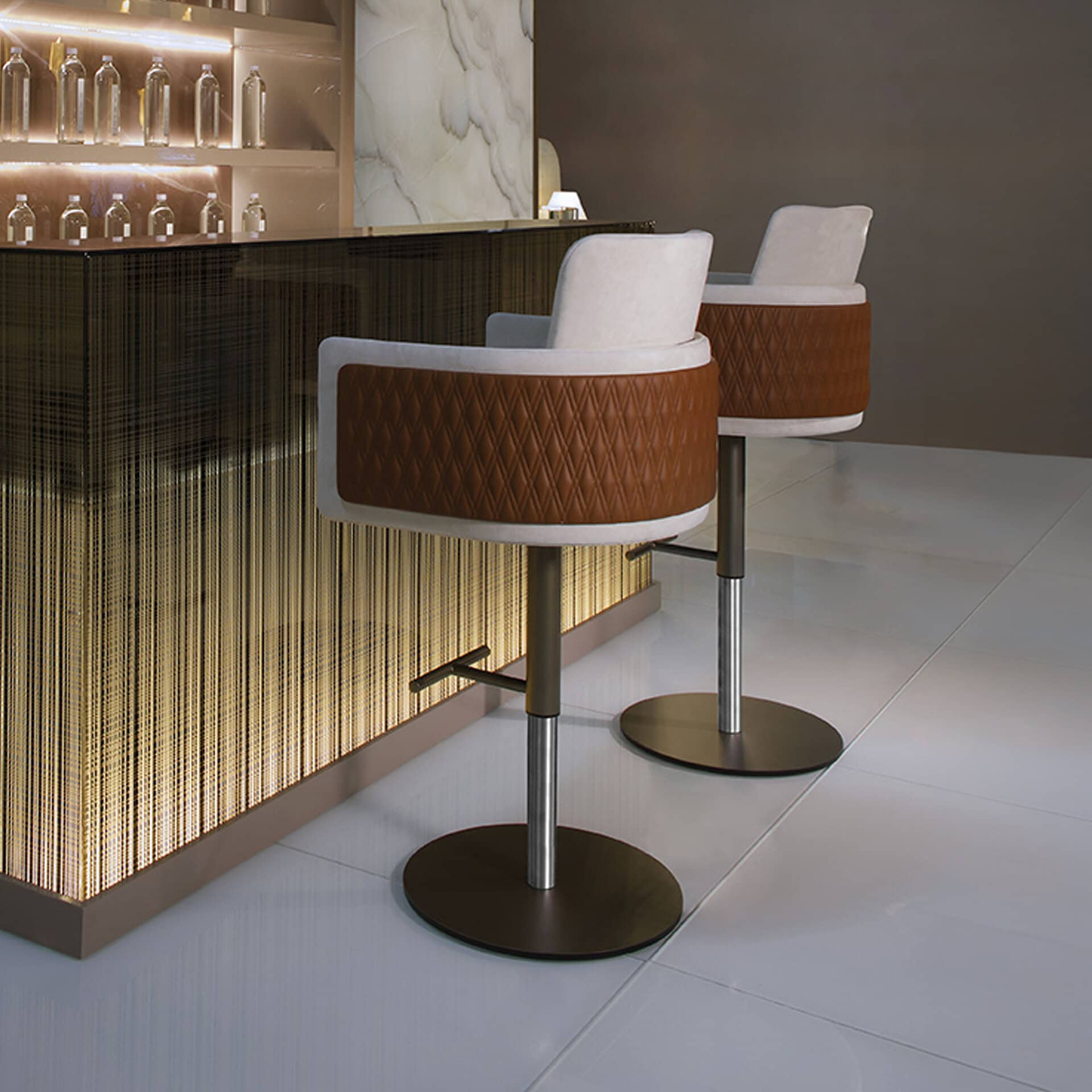 Adjustable stool with quilted brown upholstery and white backrest, ideal for modern bar or counter s.