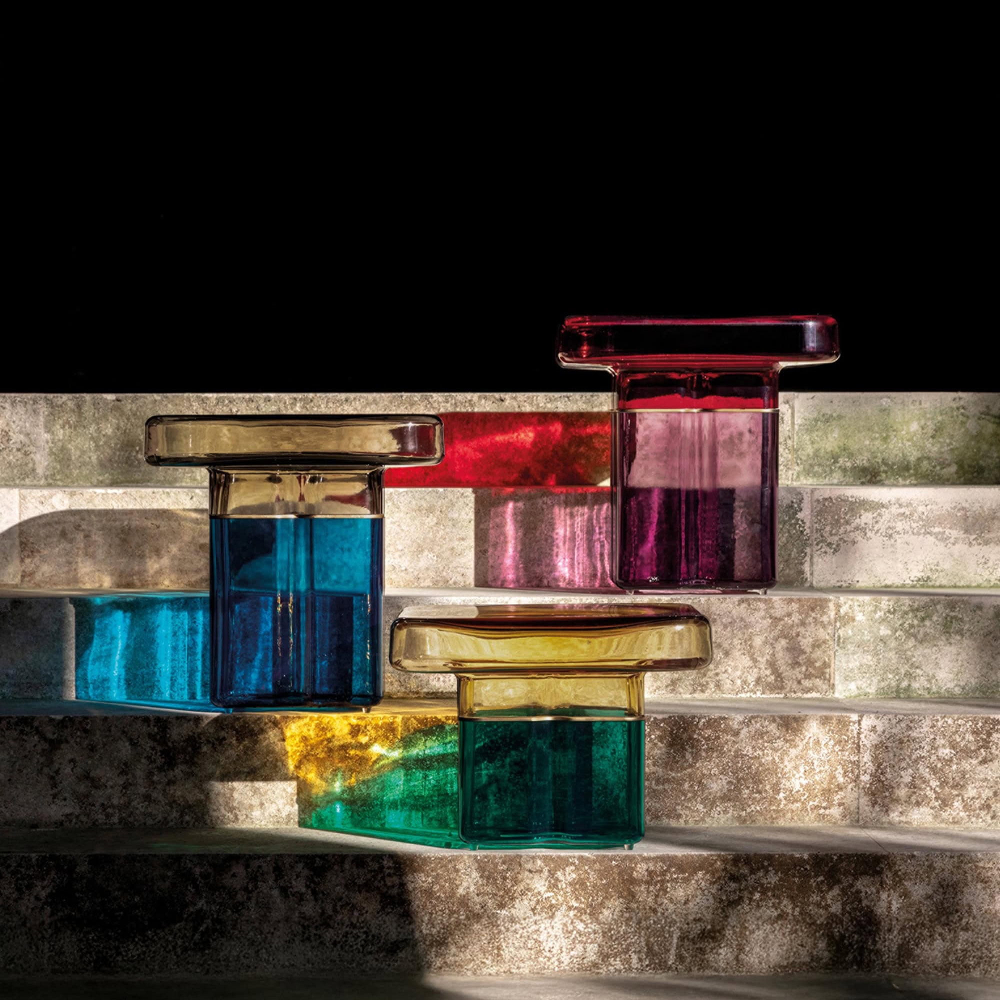 Murano glass side tables in vibrant colors, showcasing elegant craftsmanship and modern design.