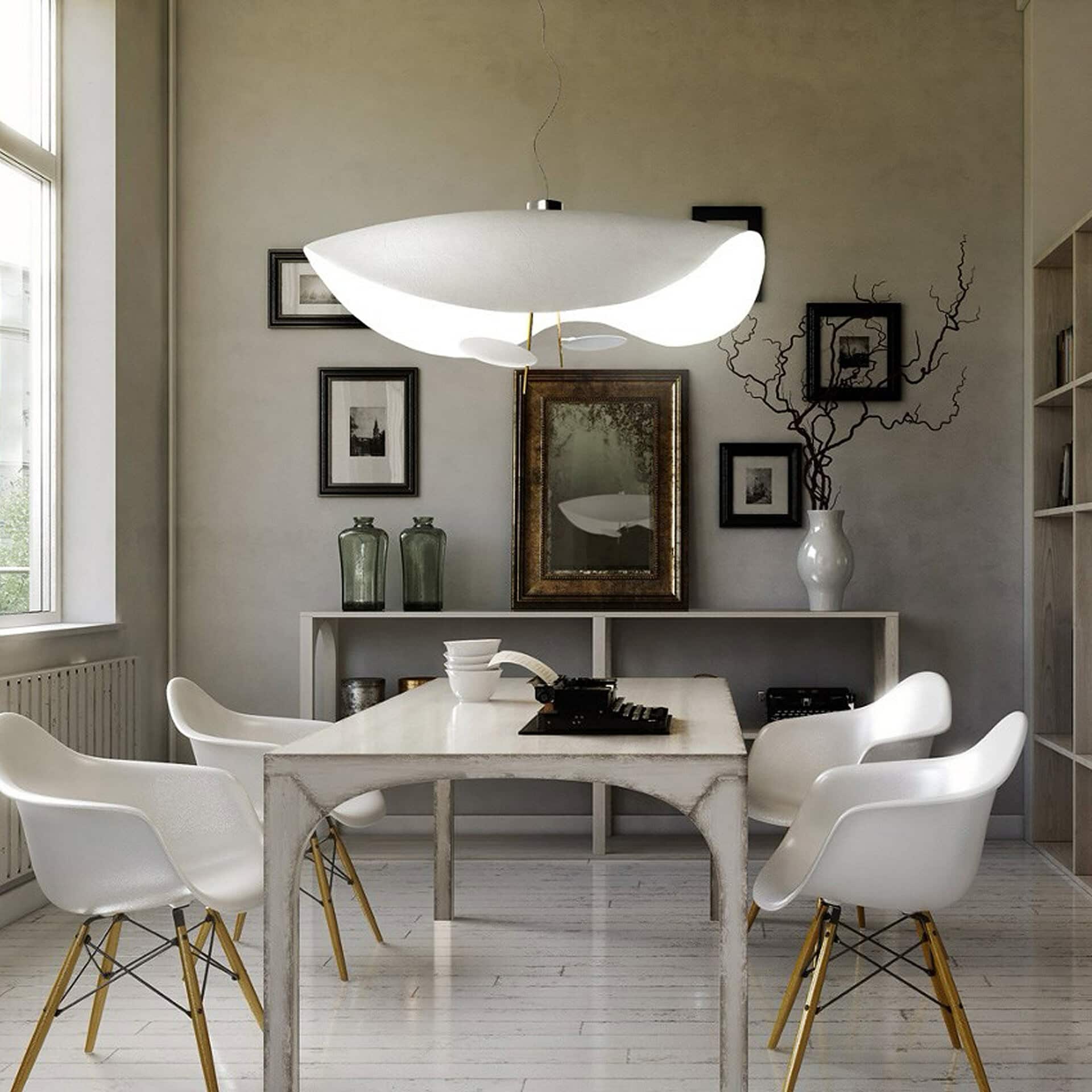 Contemporary white dining table with six chairs in a stylish, minimalist room.