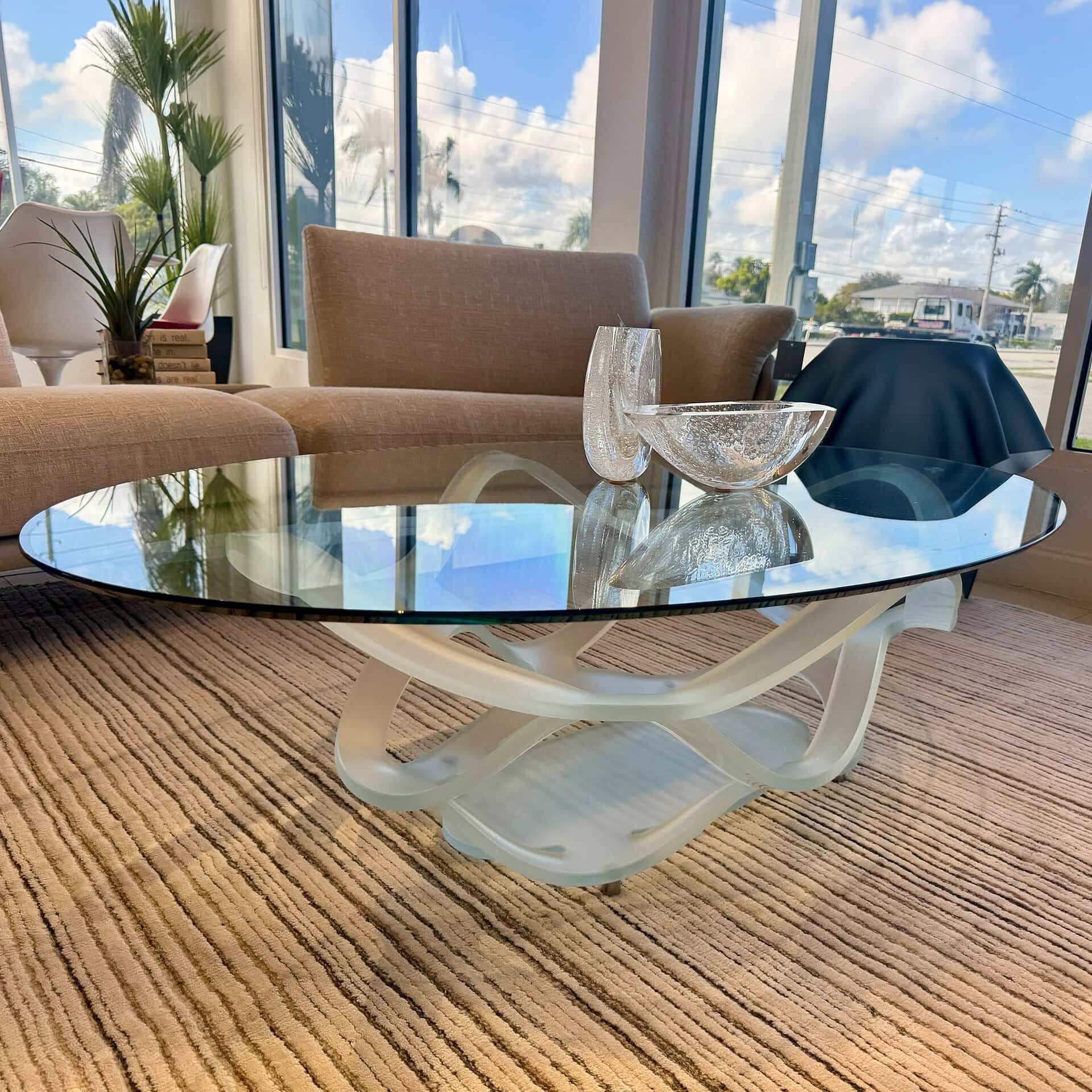 Glass coffee table with modern design and white base. Perfect for contemporary living rooms.