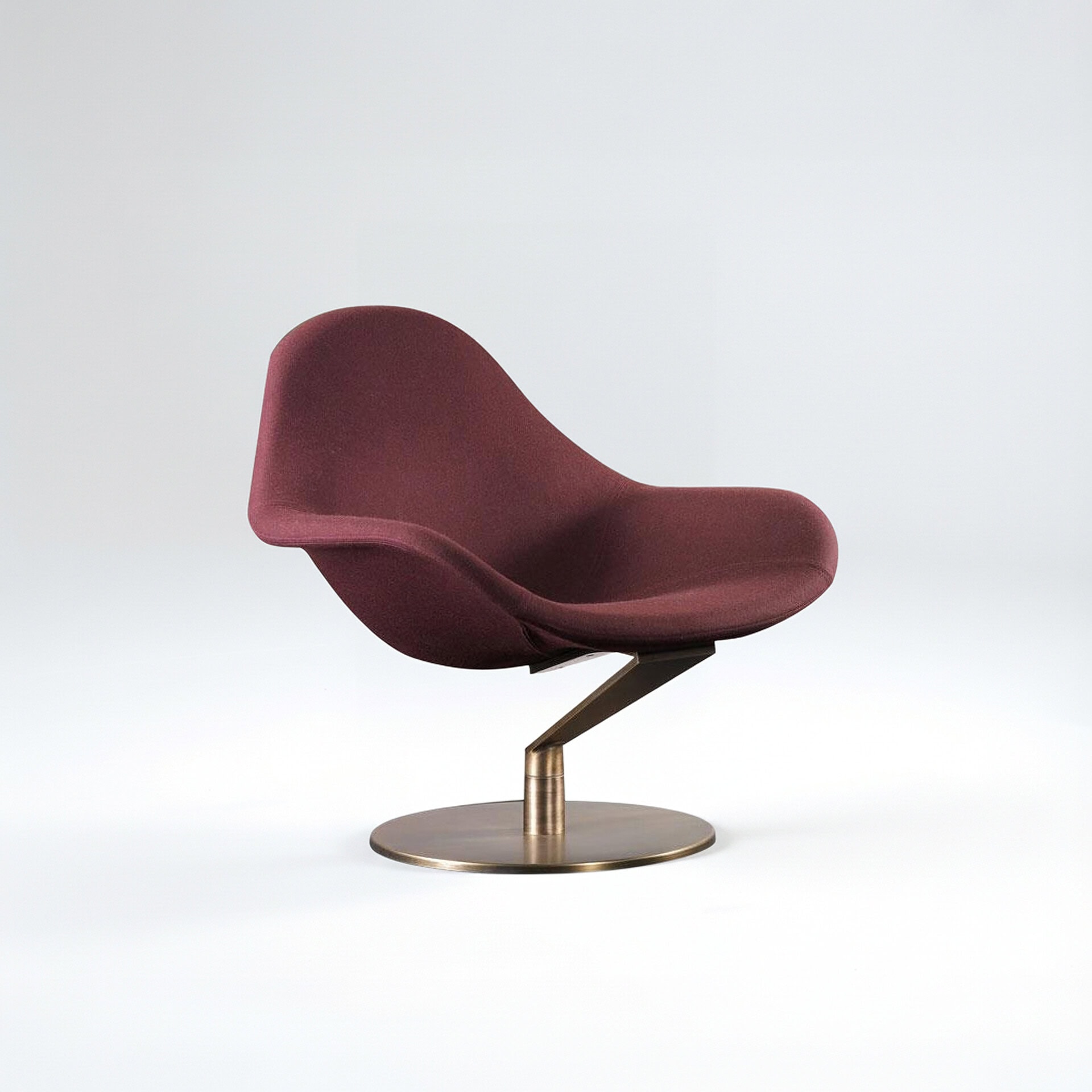 Stylish maroon lounge chair with sleek design and metal base.