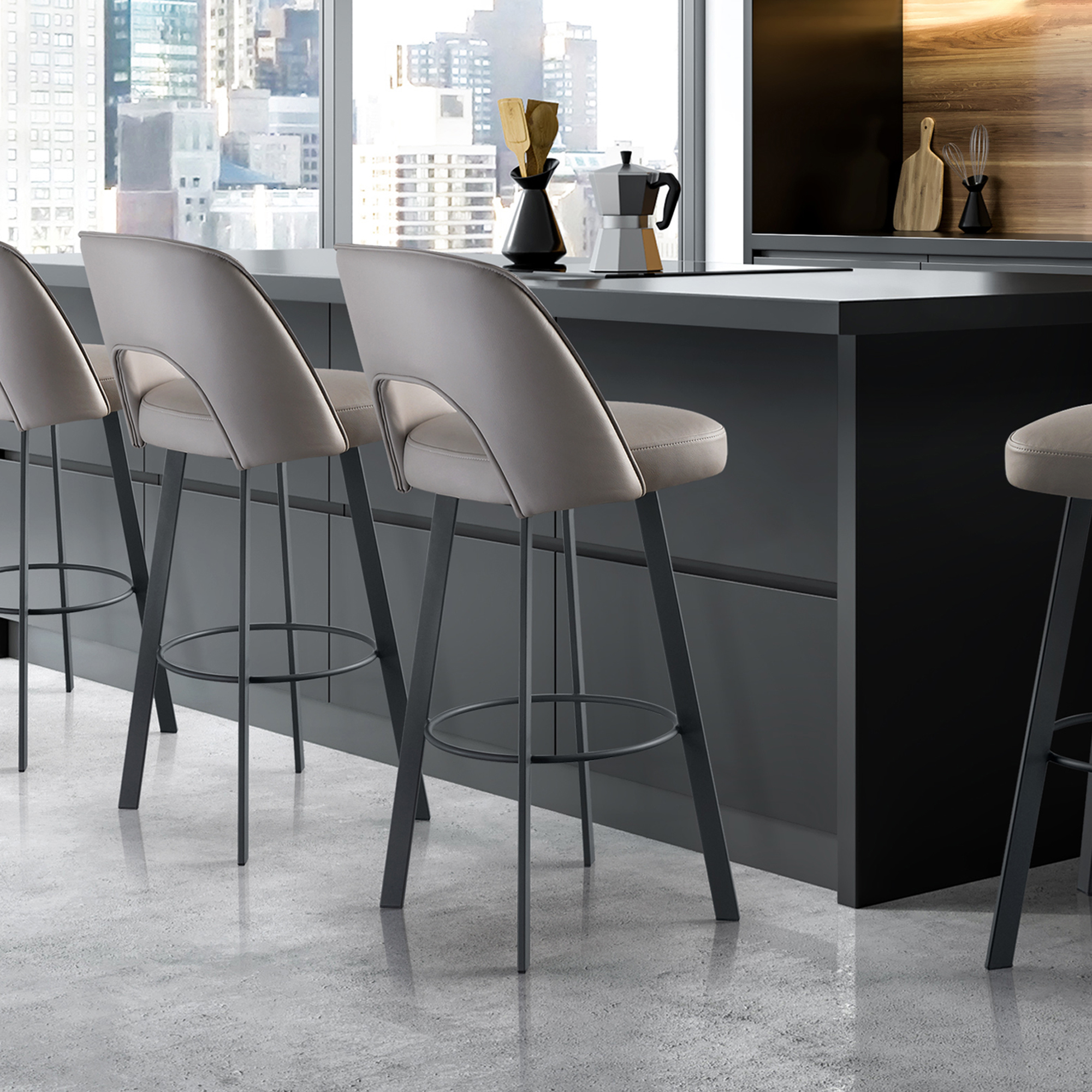 Three light grey bar stools with dark frames at a dark kitchen island, overlooking a city skyline through a large window. Kitchen accessories like a Moka pot and wooden utensils are on the counter.