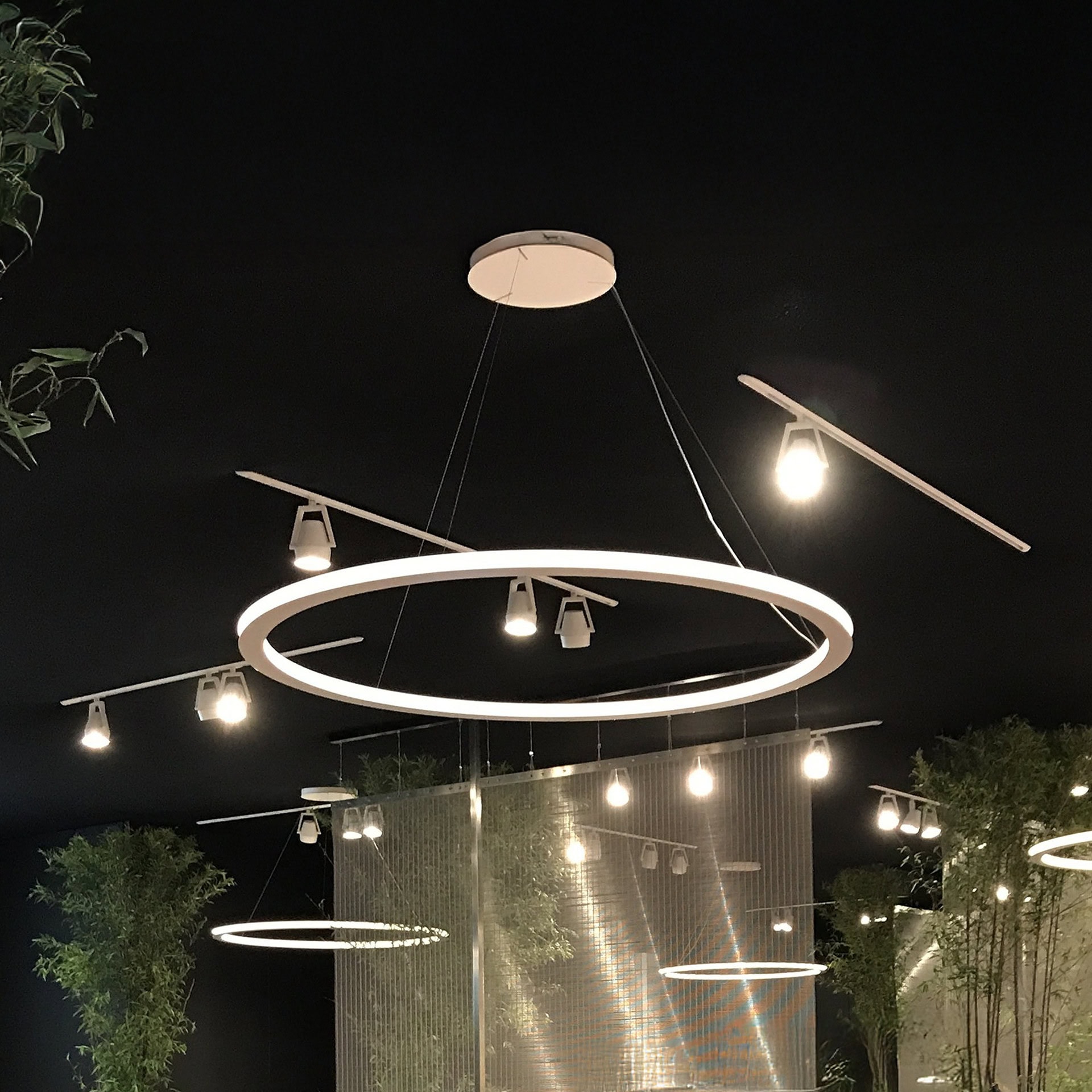 Contemporary circular pendant light with multiple bulbs, modern interior design.