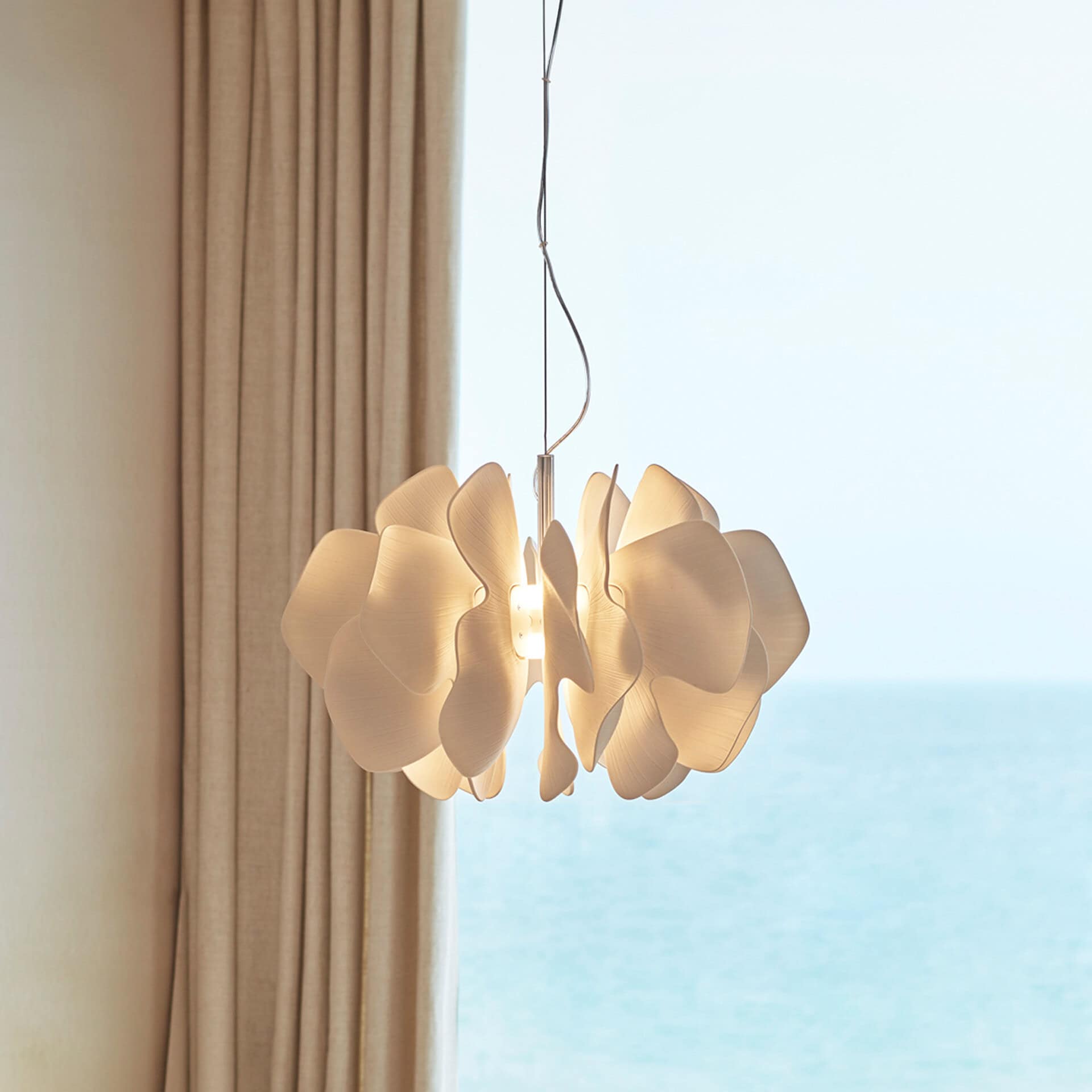 Contemporary cloud-shaped pendant light hanging in a stylish room.