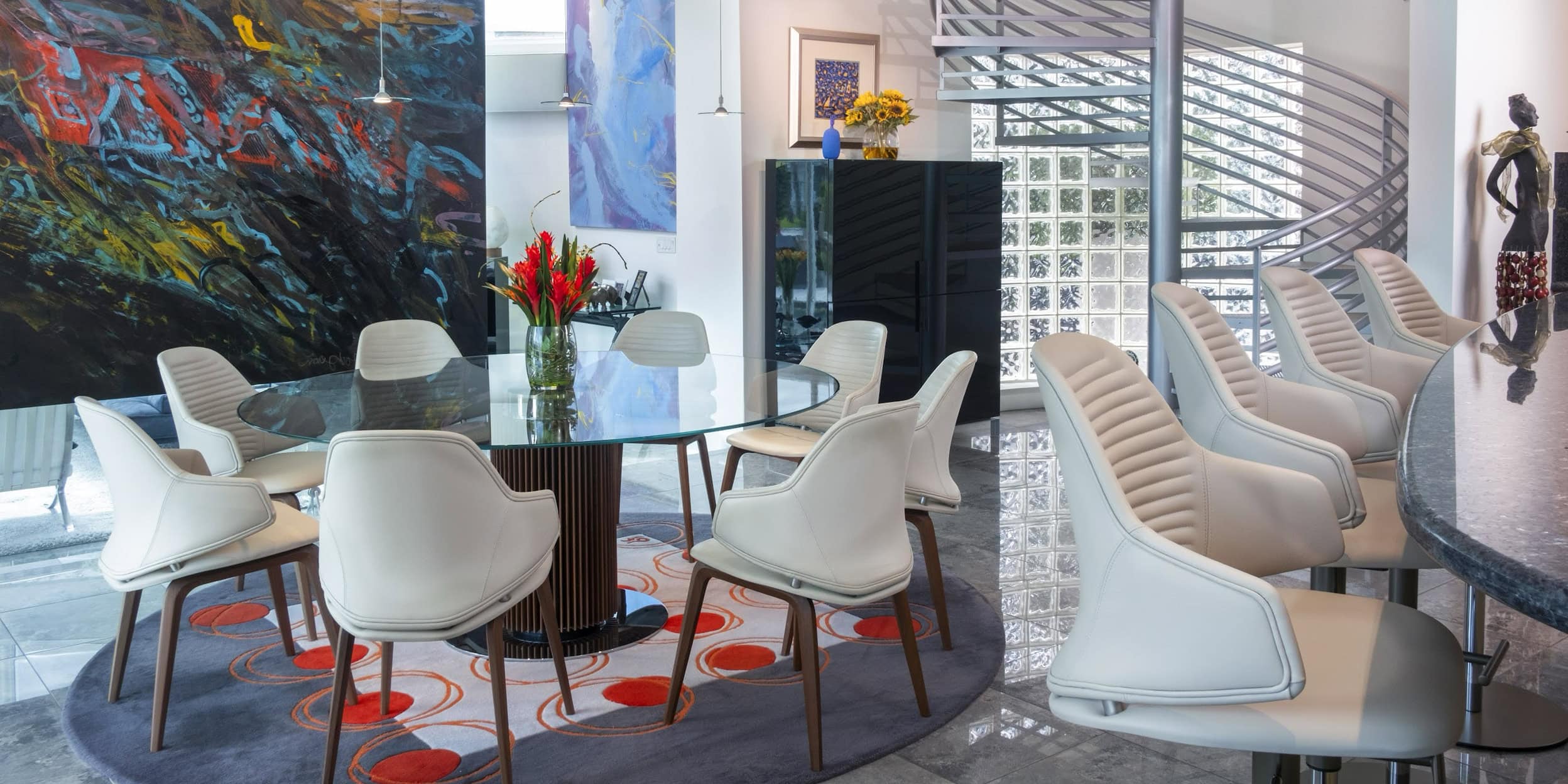 a room with a glass table and chairs