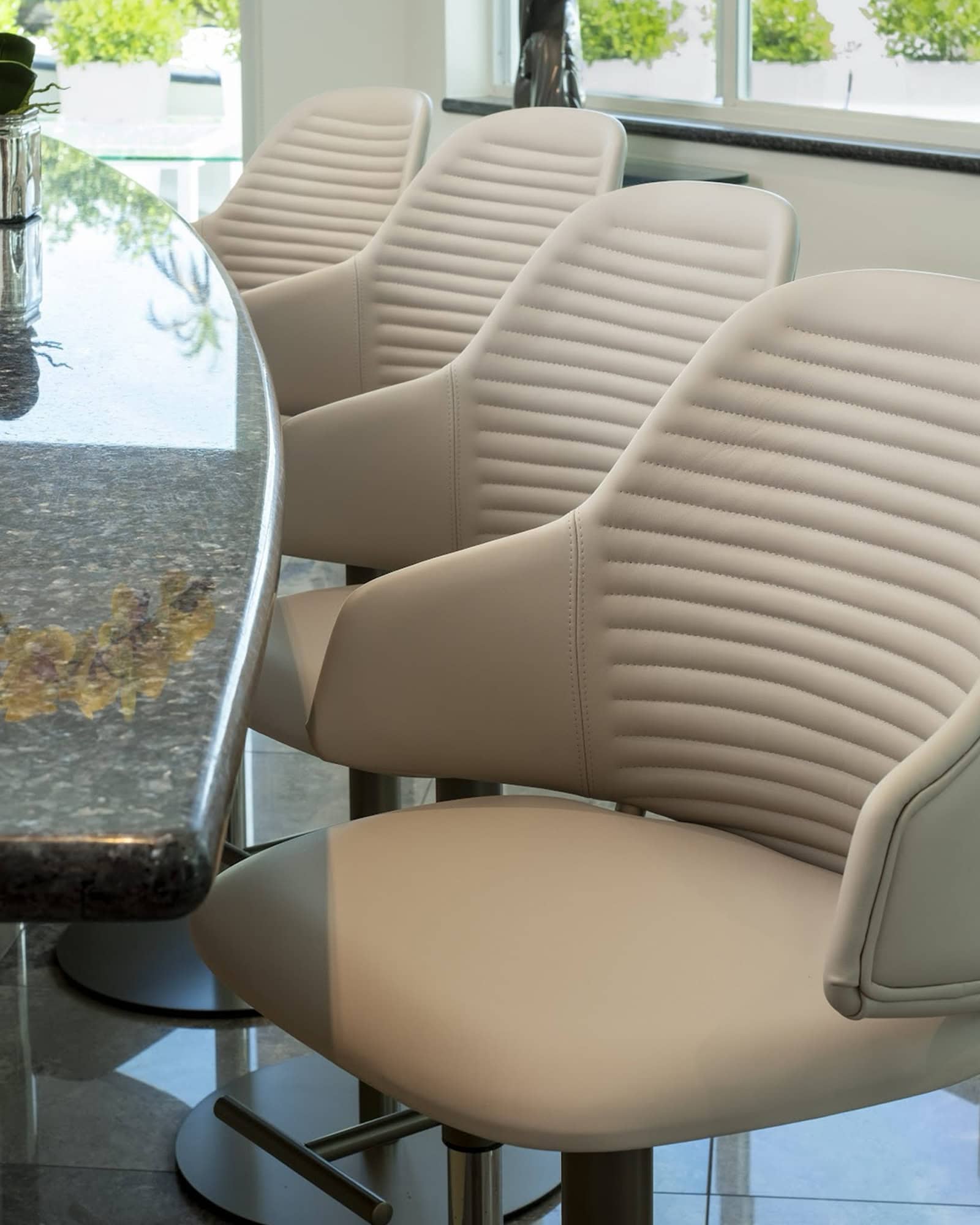 a row of chairs next to a table